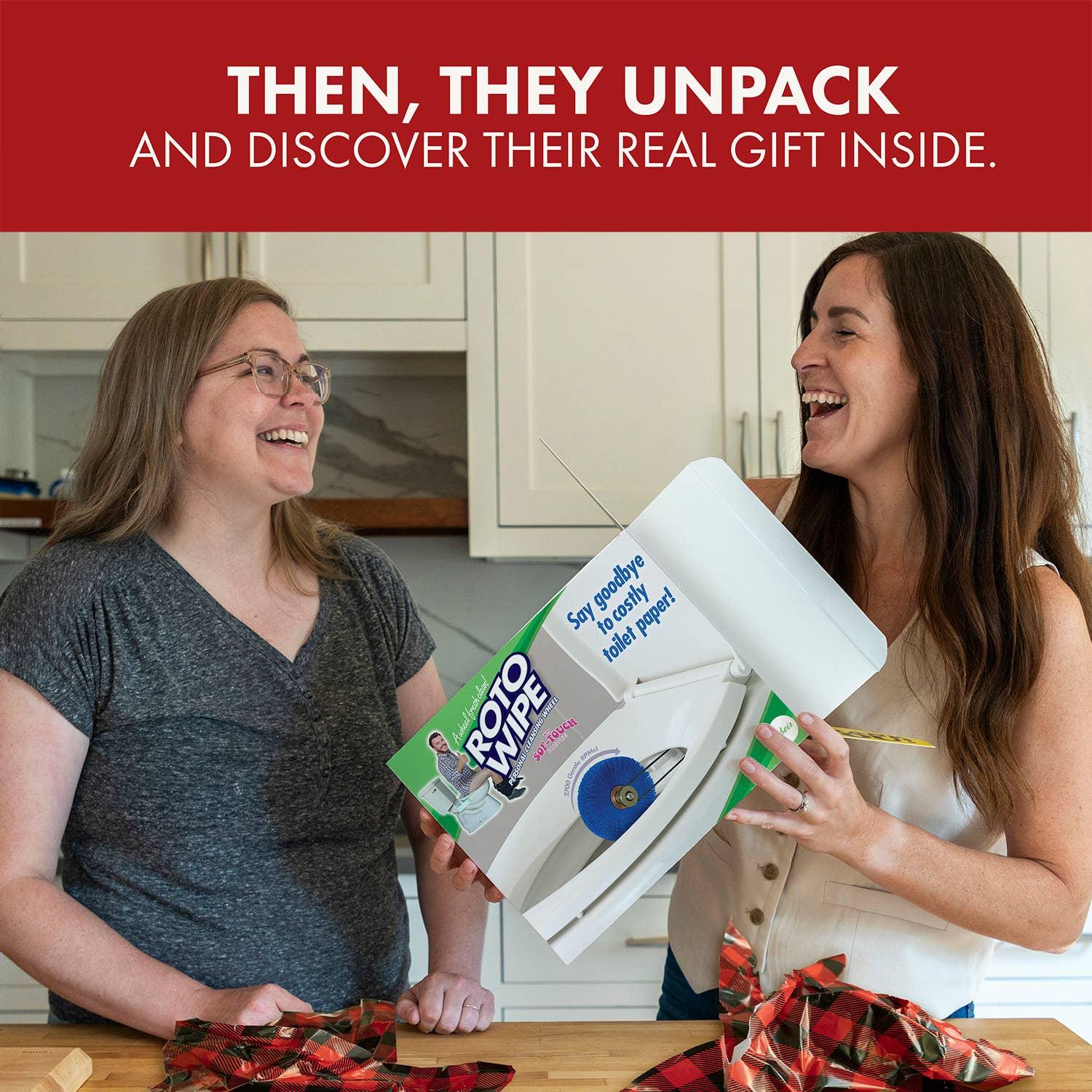 Two women laughing in a kitchen with a ROTO WIPE gag gift box, unwrapping presents.