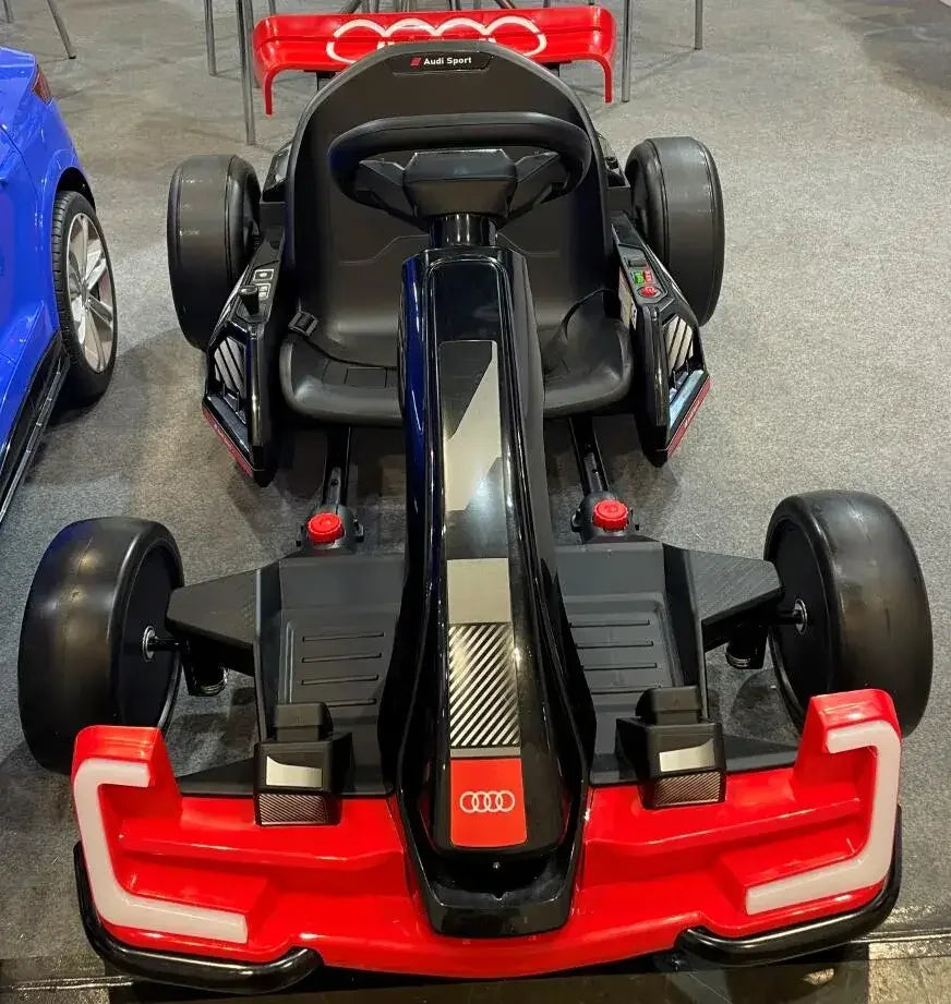 24V Audi licensed electric go-kart ride-on car in black and red on showroom floor