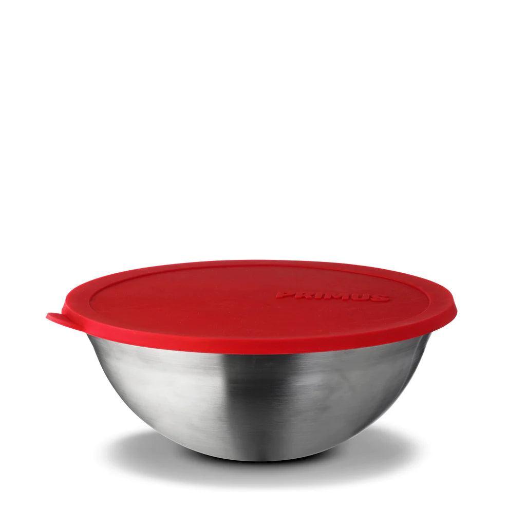 Primus stainless steel mixing bowl with red lid on white background, camp kitchen gear
