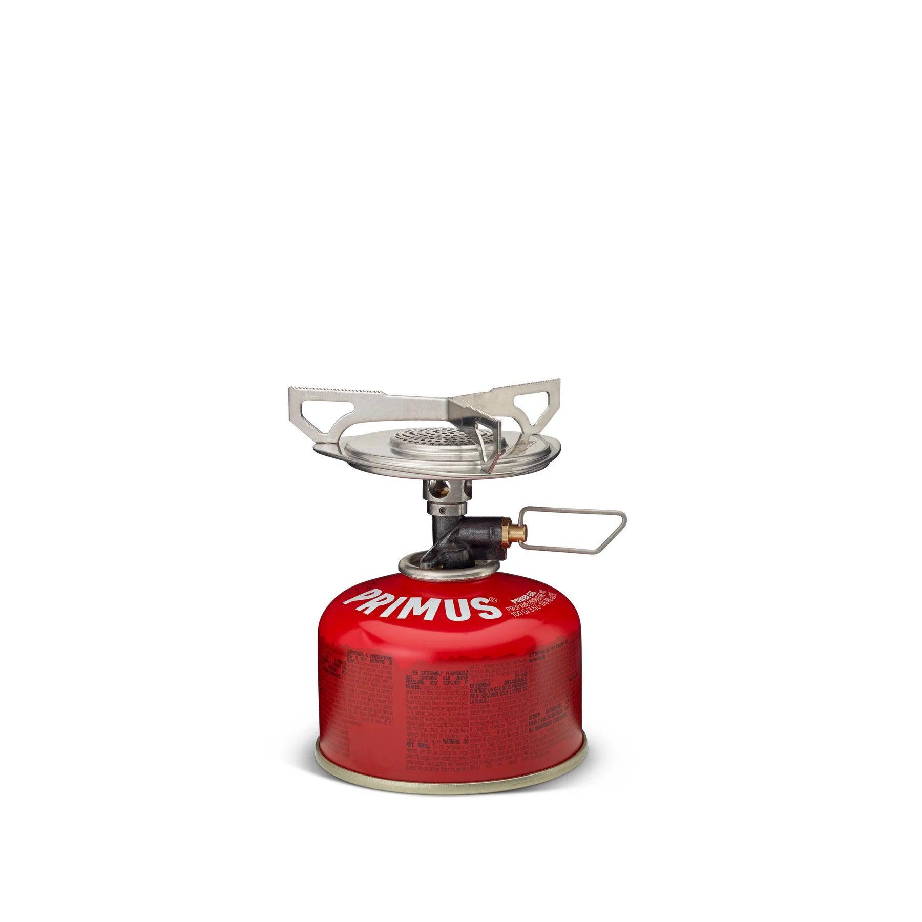 Primus Essential Trail Stove backpacking stove on red fuel canister, white background