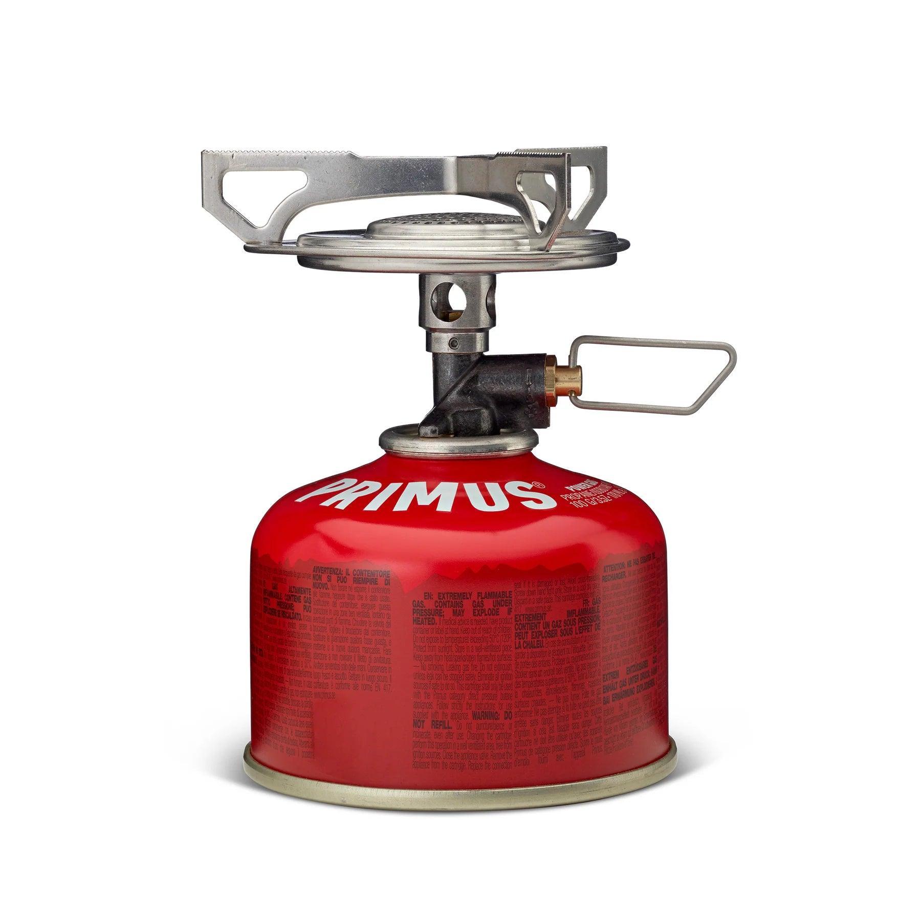 Primus Essential Trail Stove tabletop camping gas burner with red fuel canister