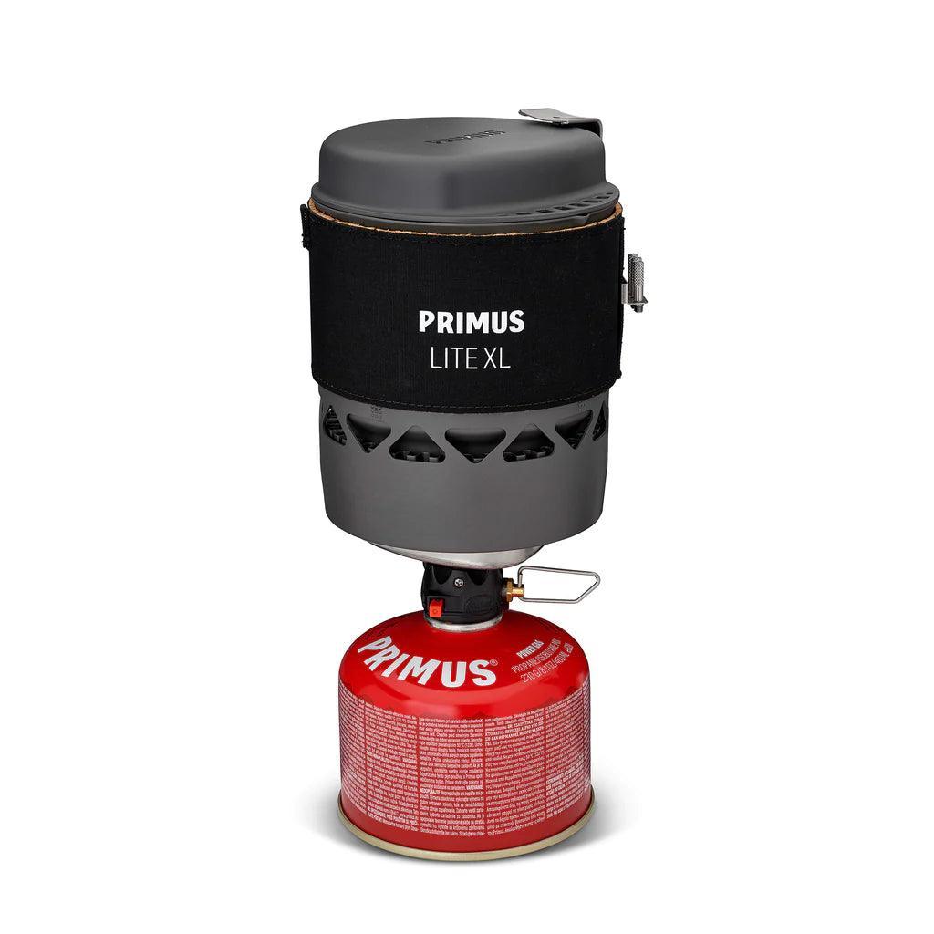 Primus Lite XL portable camping stove system with red fuel canister on white background