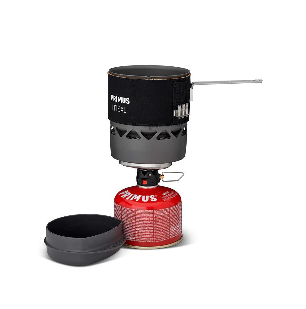 Primus Lite XL backpacking stove system with fuel canister and pot on white background