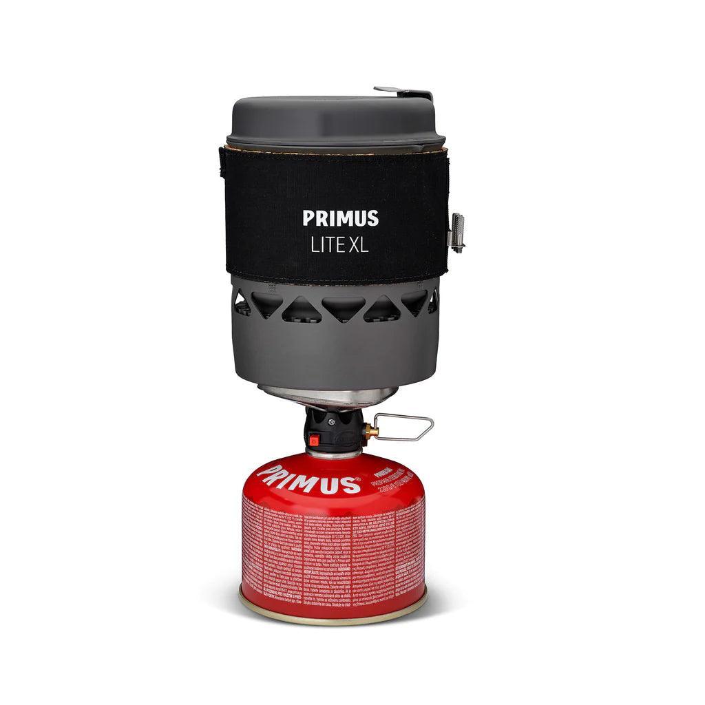 Primus Lite XL portable camping stove system with red fuel canister on white background