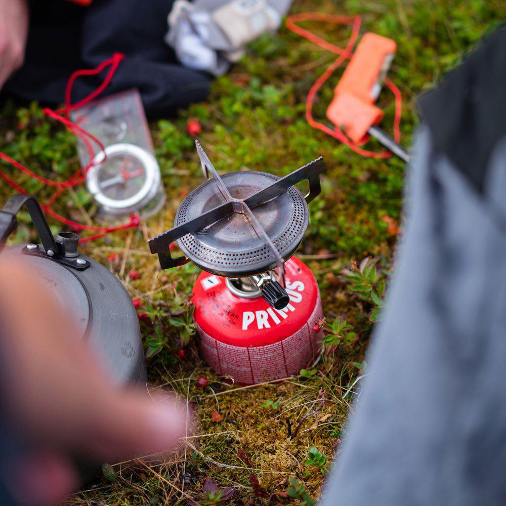 Primus Mimer camping gas stove on grass with kettle outdoors