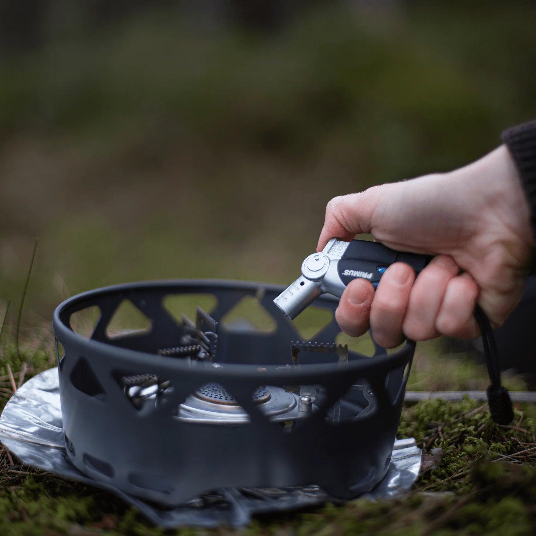 Hand lighting portable camping stove with Primus power lighter outdoors