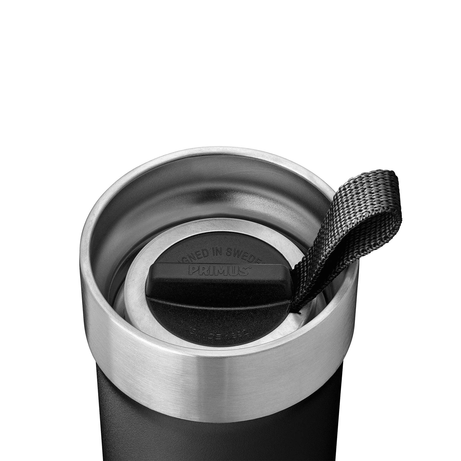 Black stainless steel vacuum mug with Primus lid and black woven strap, close-up view