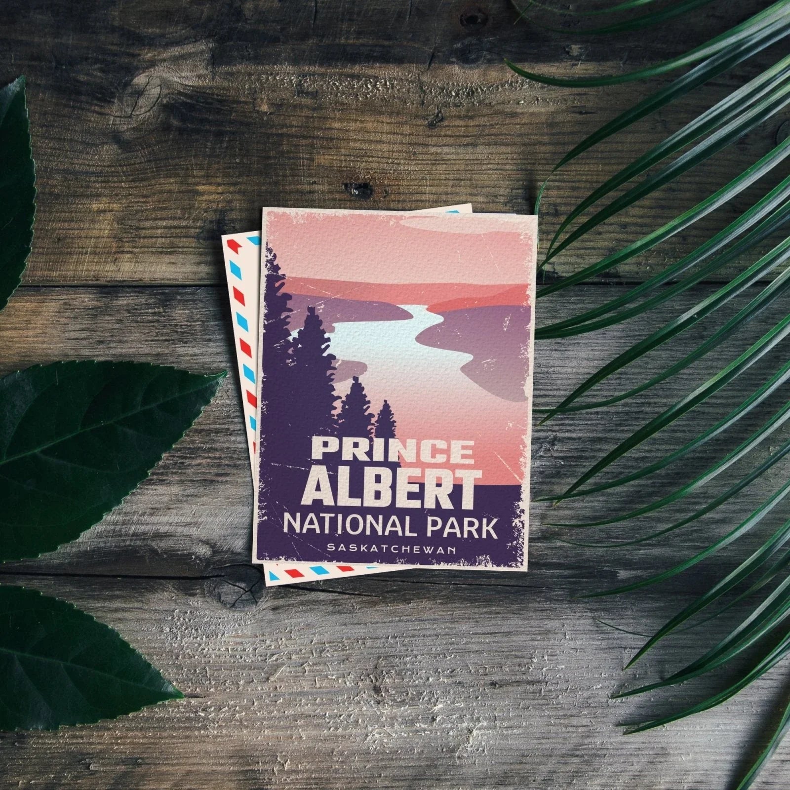 Prince Albert National Park postcard on rustic wood with green leaves, Saskatchewan souvenir
