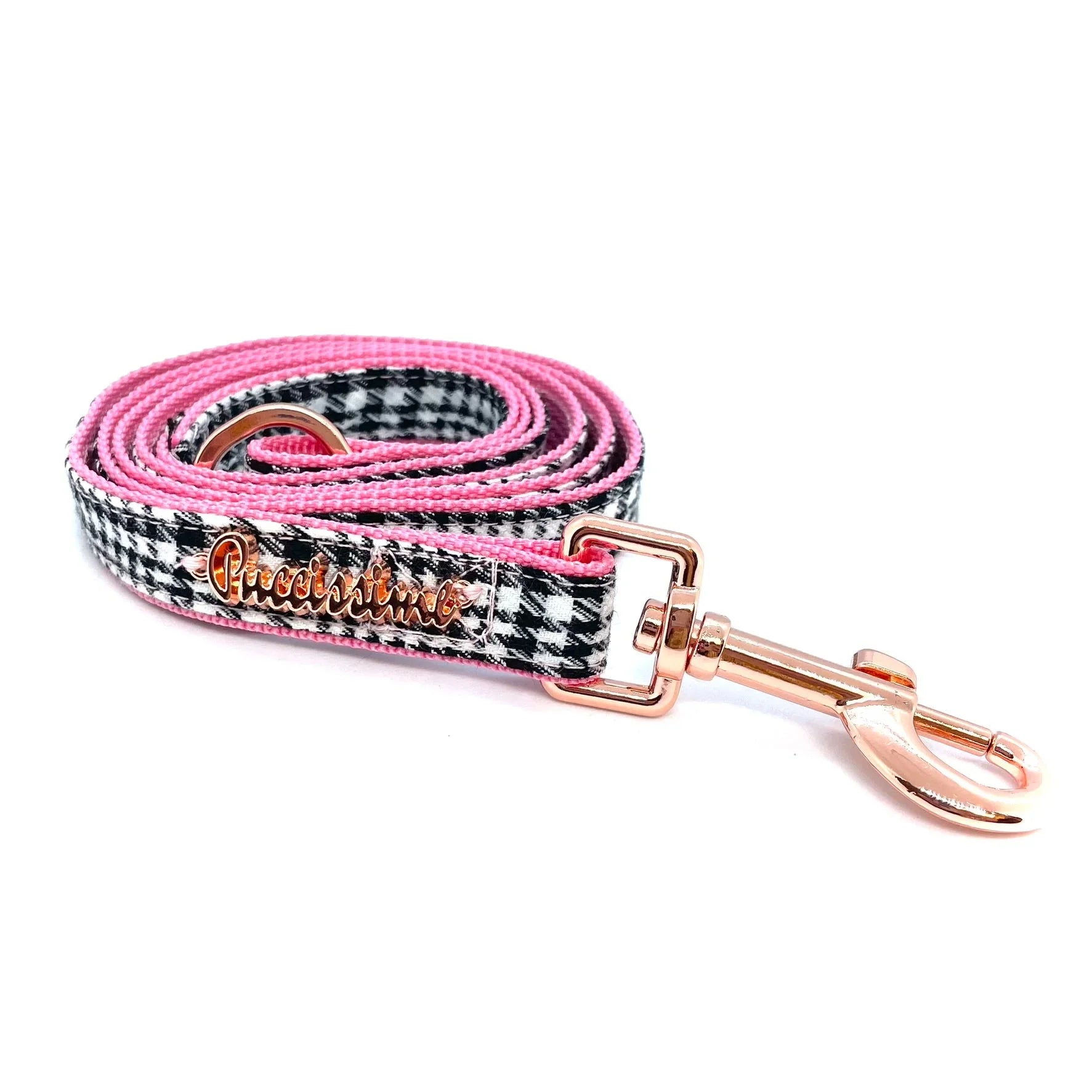 Pink and black houndstooth dog leash with gold metal clasp on white background