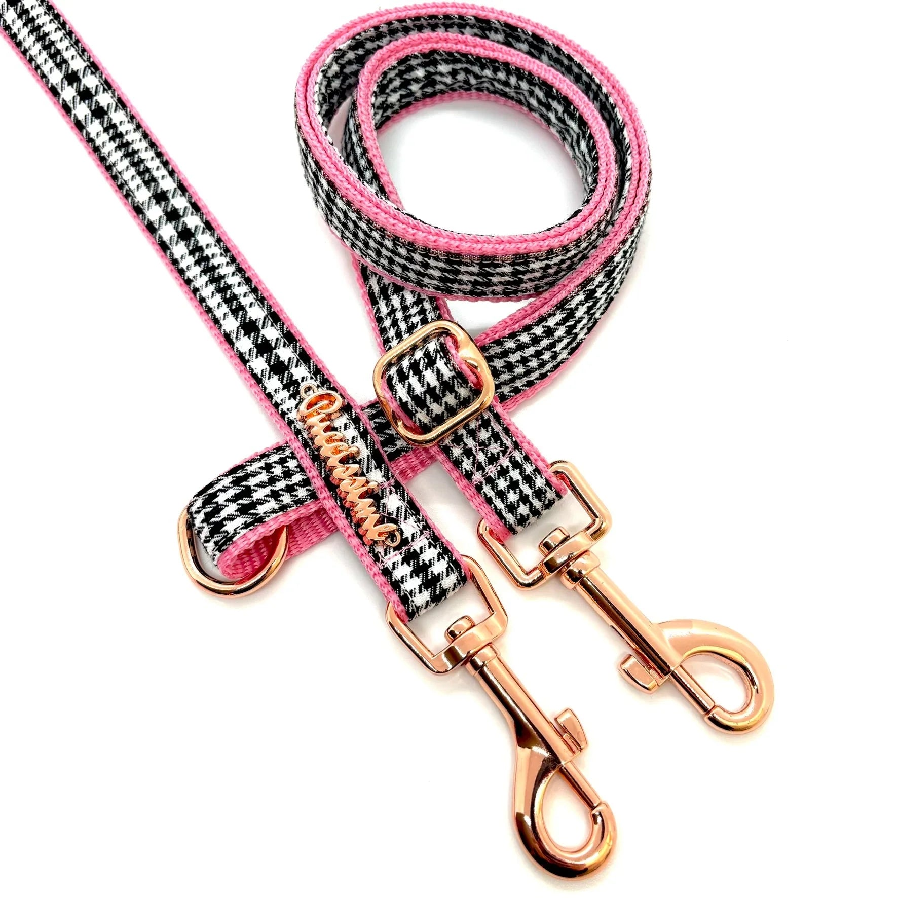Pink and black houndstooth dog leash with rose gold metal clips on white background