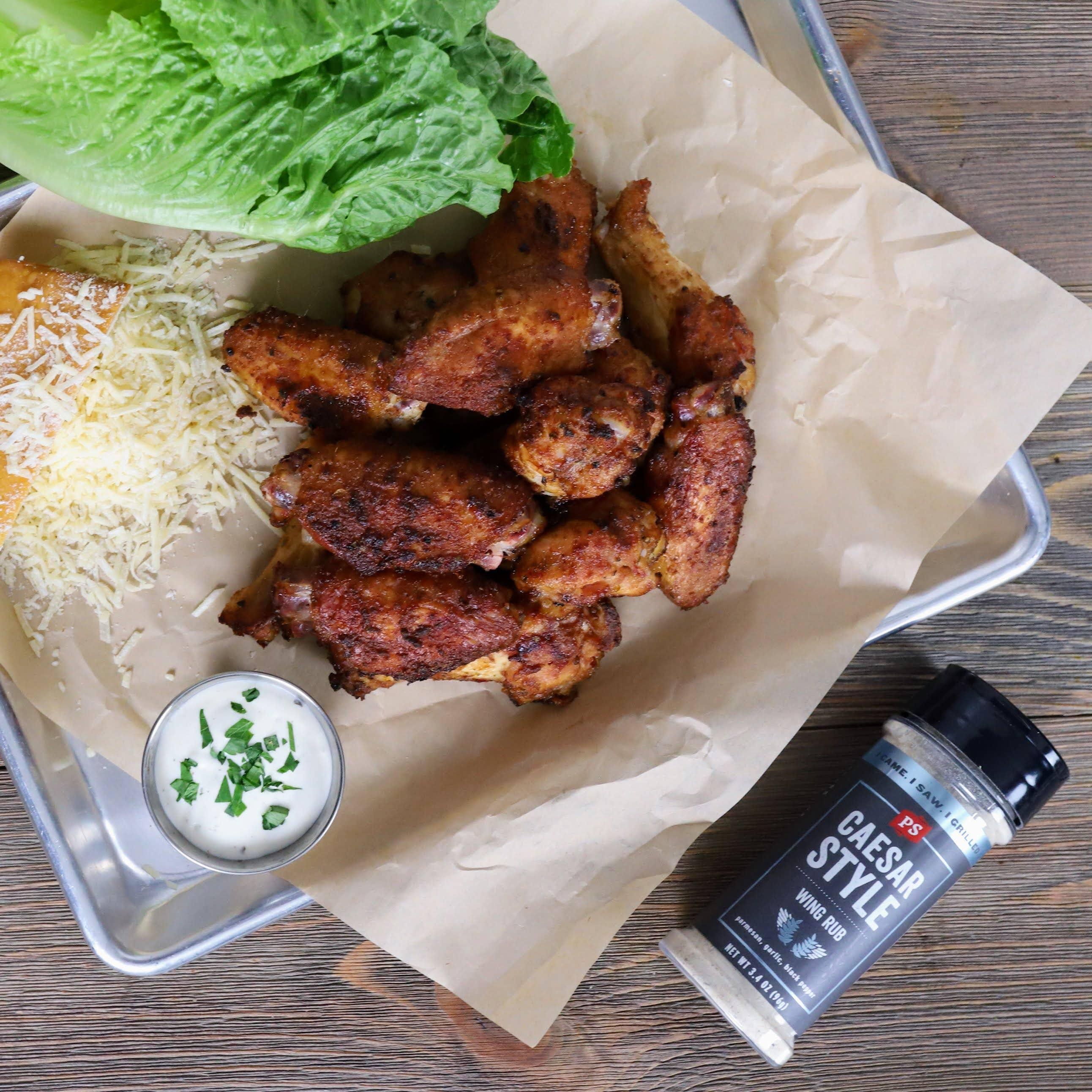 Caesar Style wing rub seasoning with cooked chicken wings, ranch dip, lettuce, and cheese