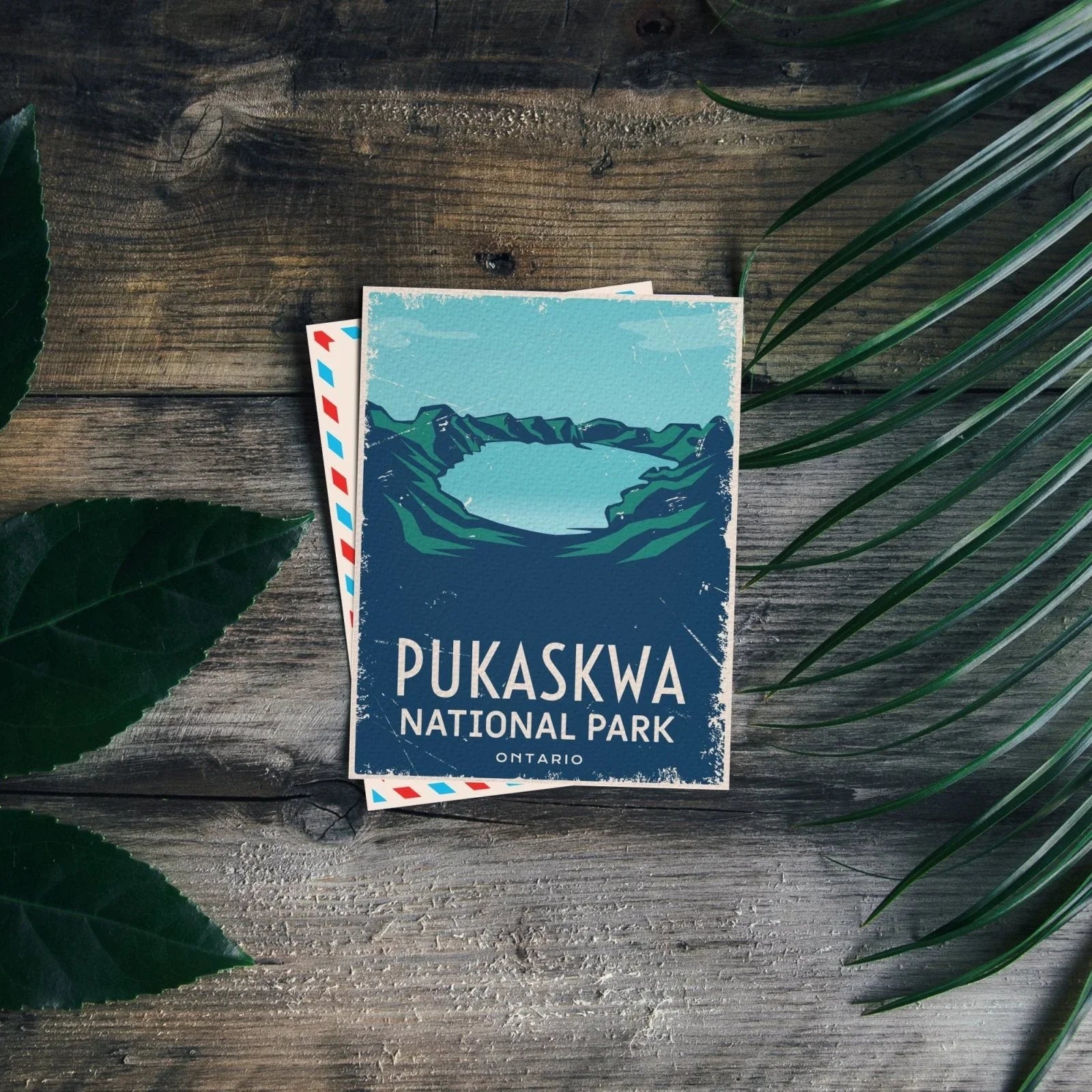 Pukaskwa National Park Ontario postcard on wooden table with green leaves