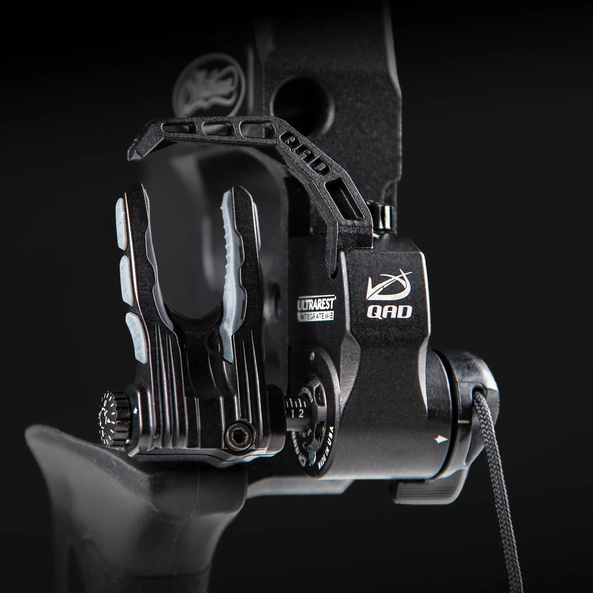 Close-up of a QAD UltraRest Integrate MX2 arrow rest on a black compound bow