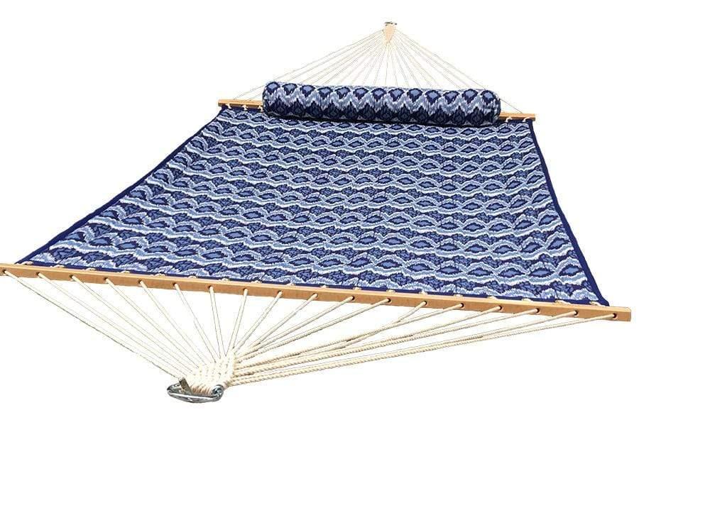 Blue and white quilted hammock with geometric patterns and wooden spreader bars