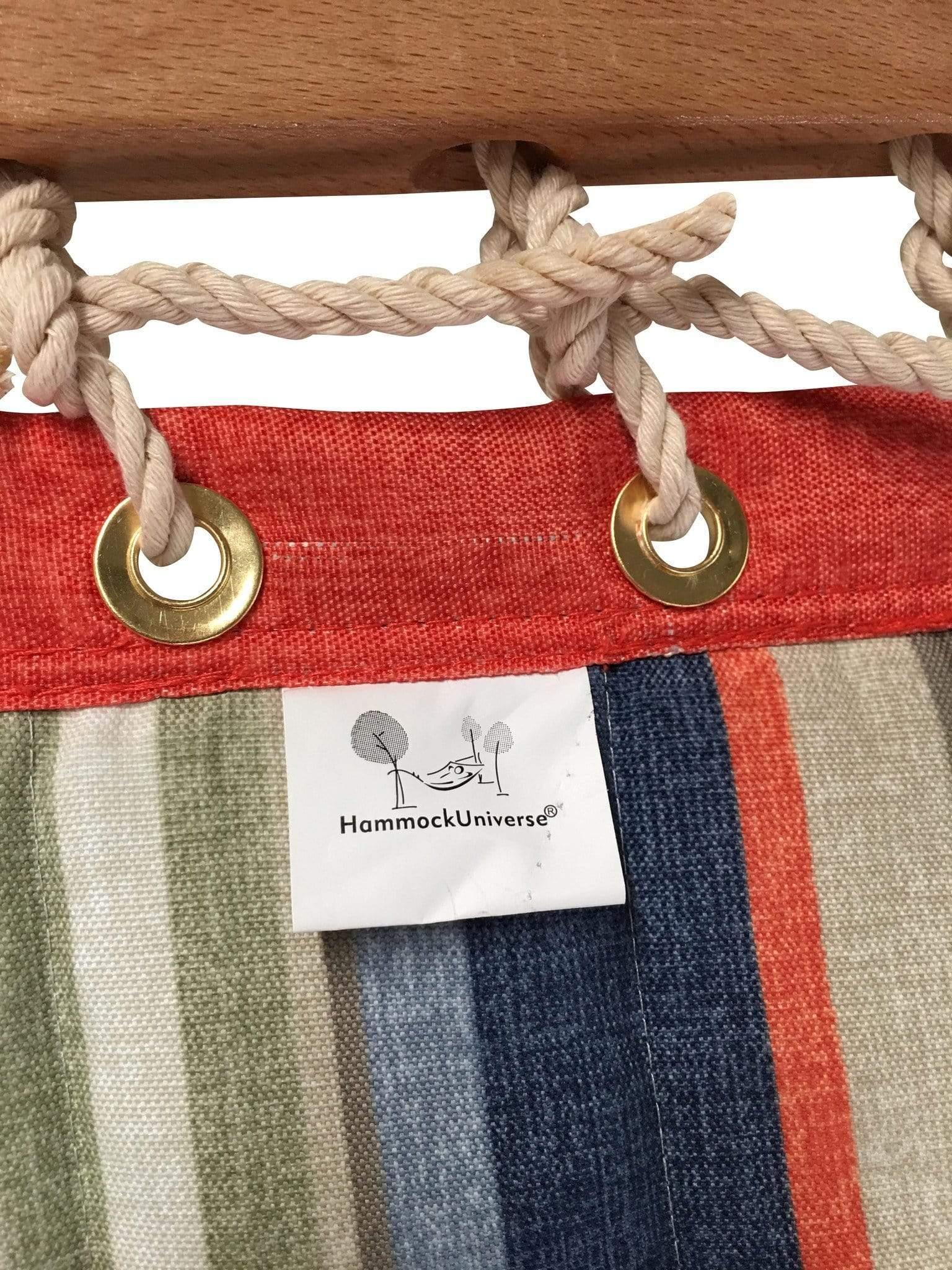 Striped quilted hammock fabric with wooden spreader bar, brass grommets, and Hammock Universe label