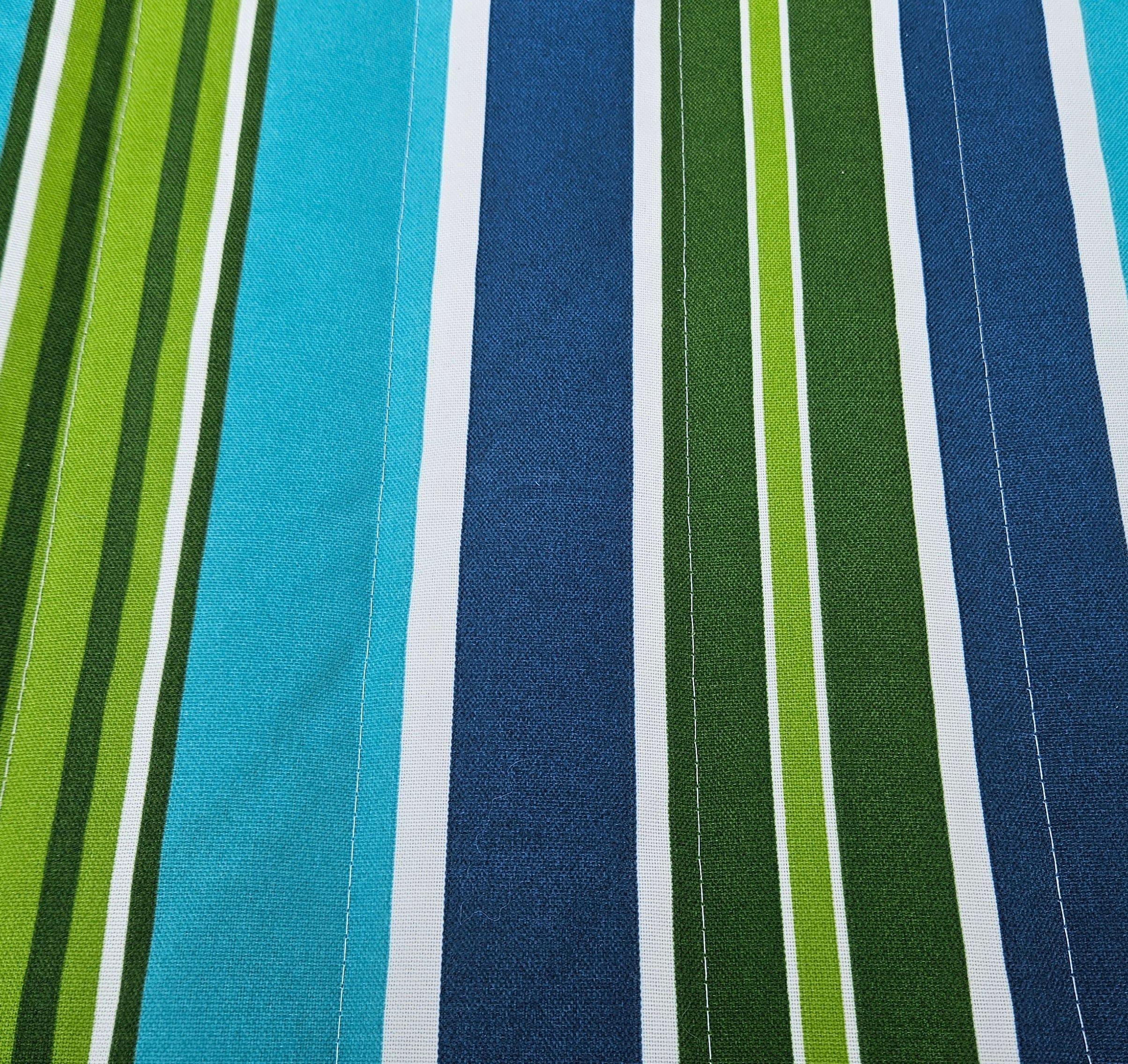 Blue and green striped outdoor fabric pattern with white accents