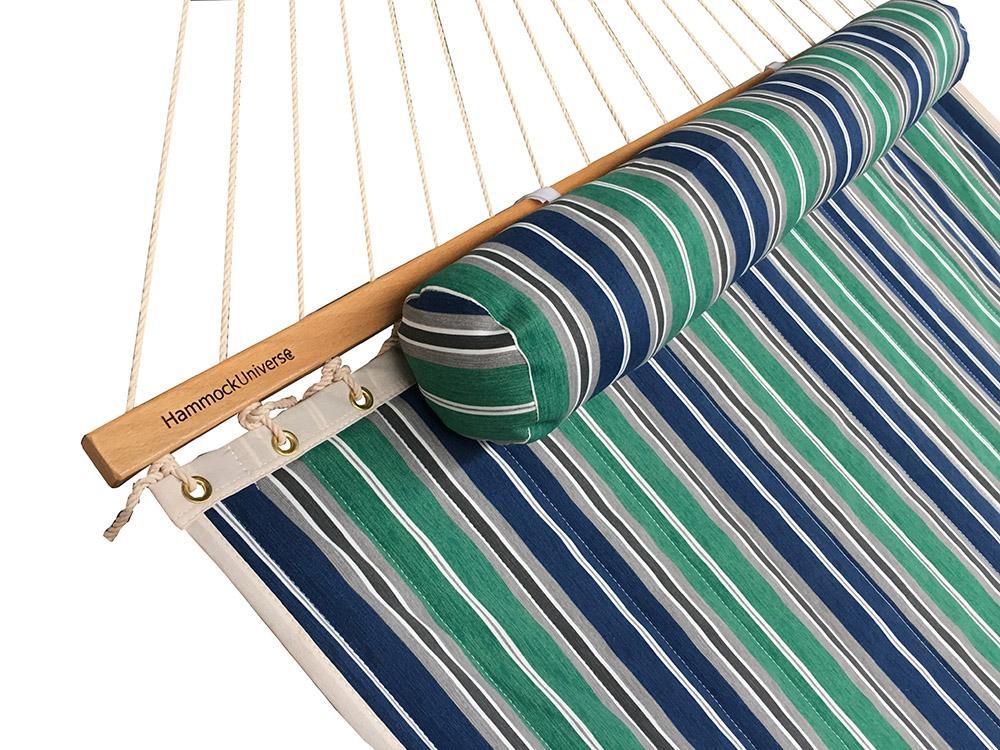 Quilted hammock with green, blue, grey, and white stripes and built-in headrest
