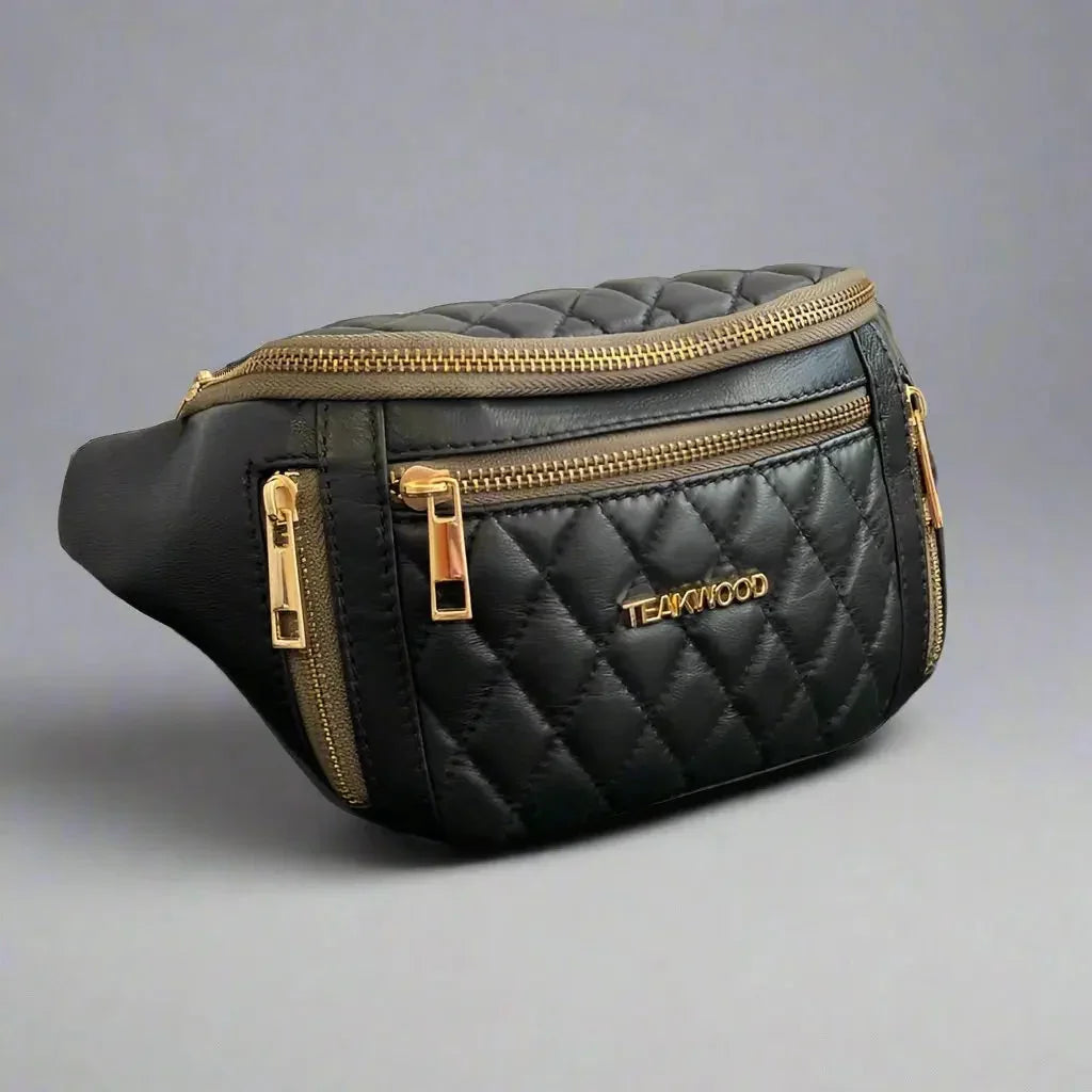Quilted black sheep leather waist bag with gold zippers and TEAKWOOD logo on gray background