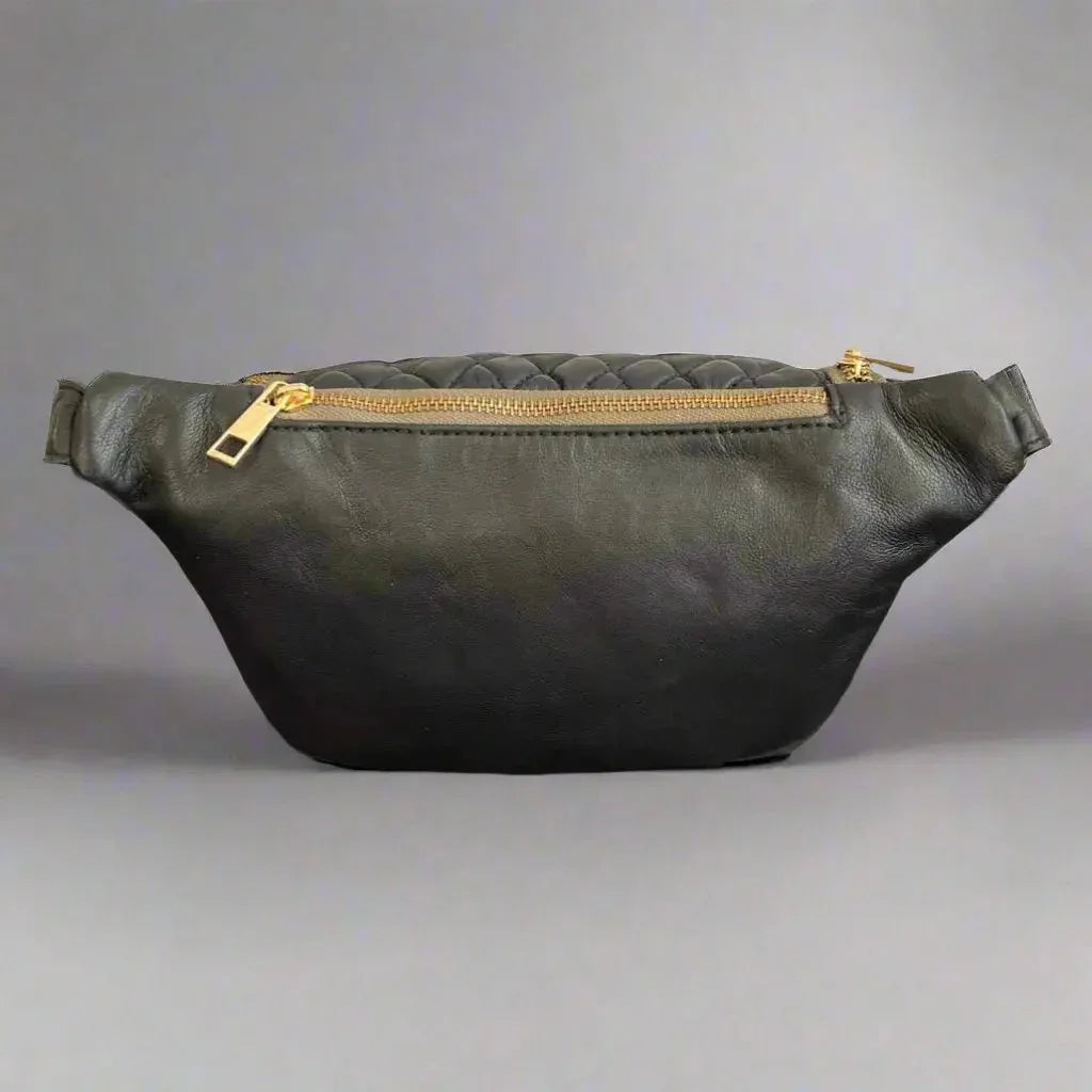 Black quilted sheep leather waist bag with gold zipper, minimalist design on gray background