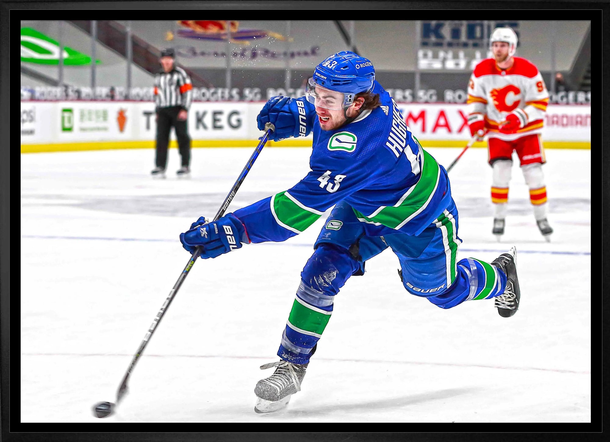 Vancouver Canucks hockey player taking a shot on ice during game against Calgary Flames.