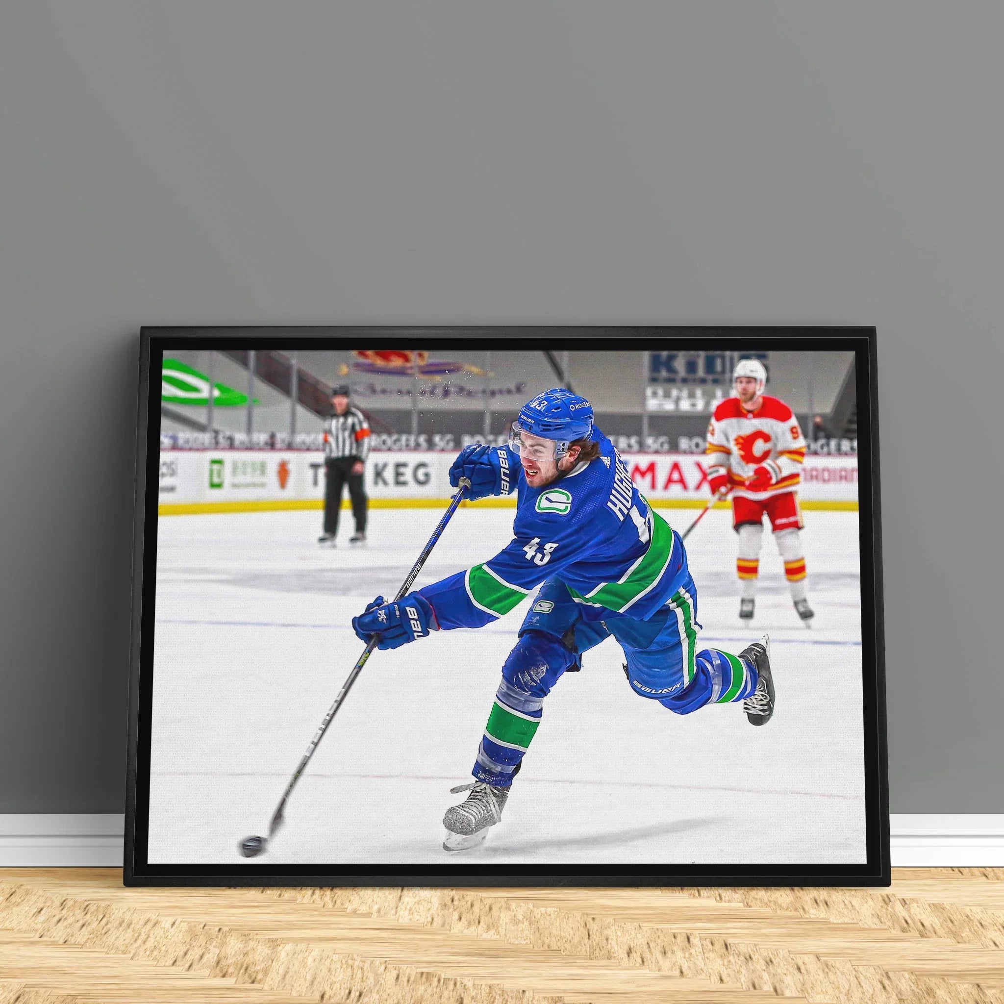 Hockey player in blue jersey shooting puck on ice rink, framed sports art print