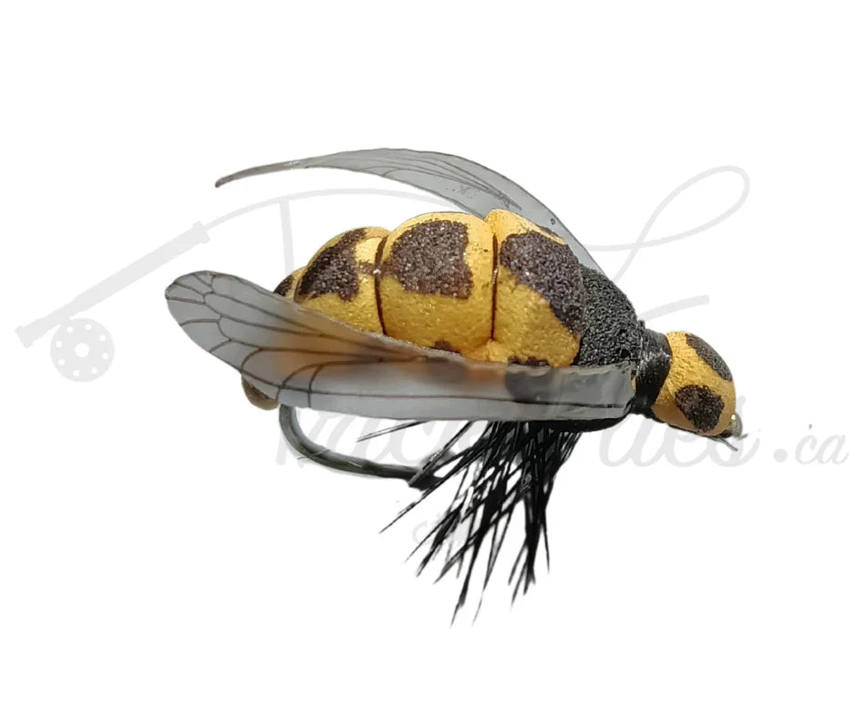 Realistic wasp fishing fly with yellow and black body, translucent wings, and black tail