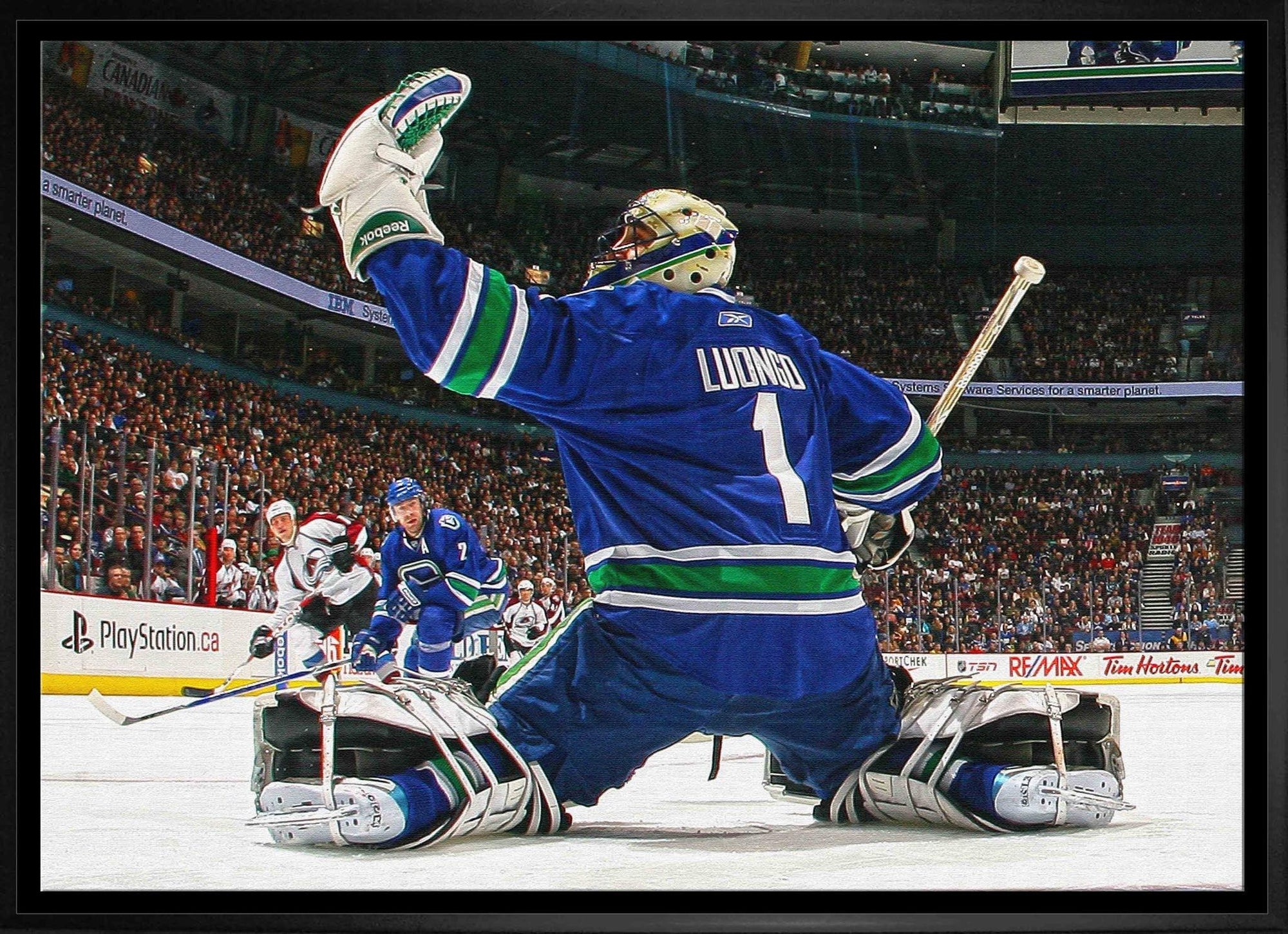 Ice hockey goalie in blue Canucks jersey making a glove save during game, crowded arena