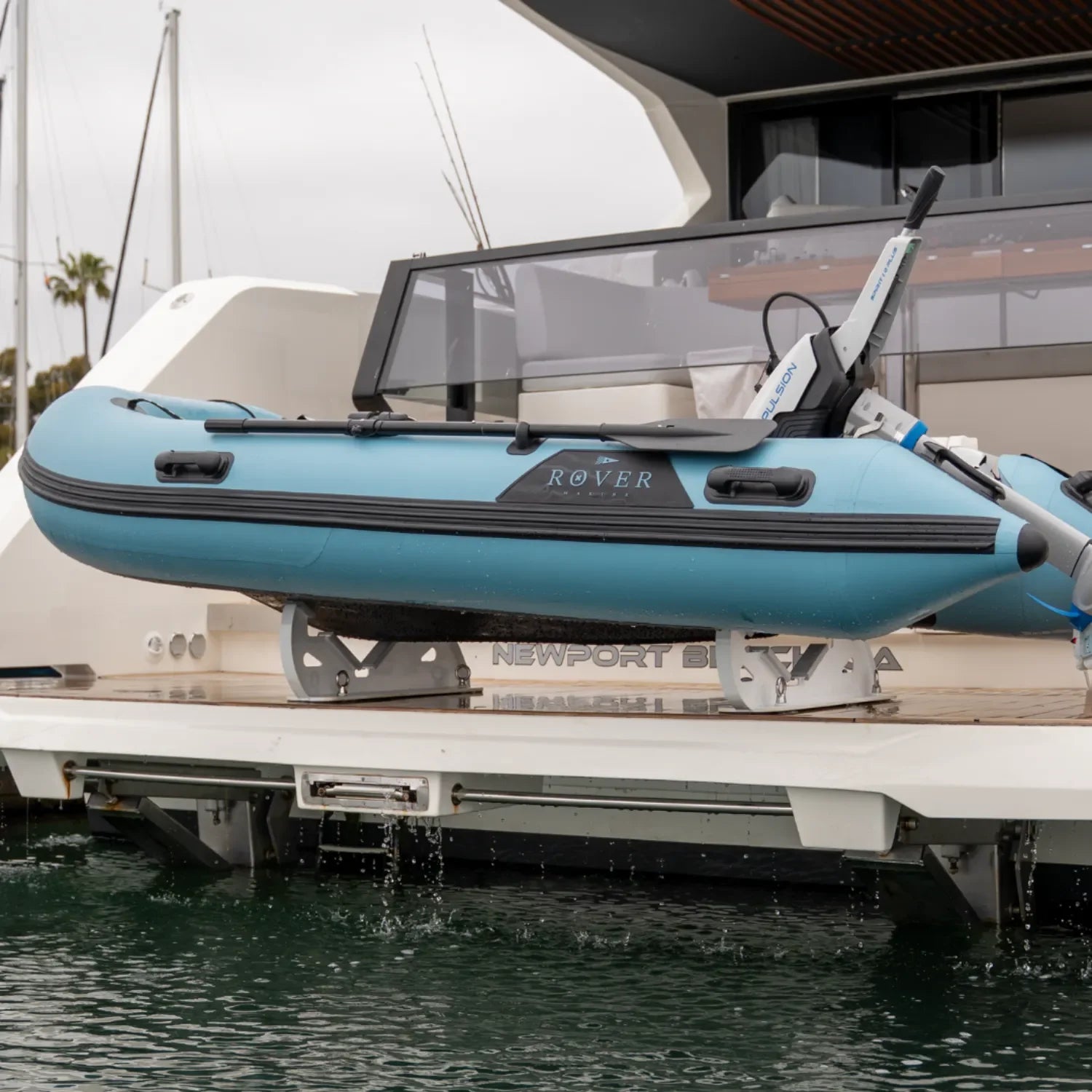 Rover Marine Battle Boat inflatable tender secured on a yacht in a marina