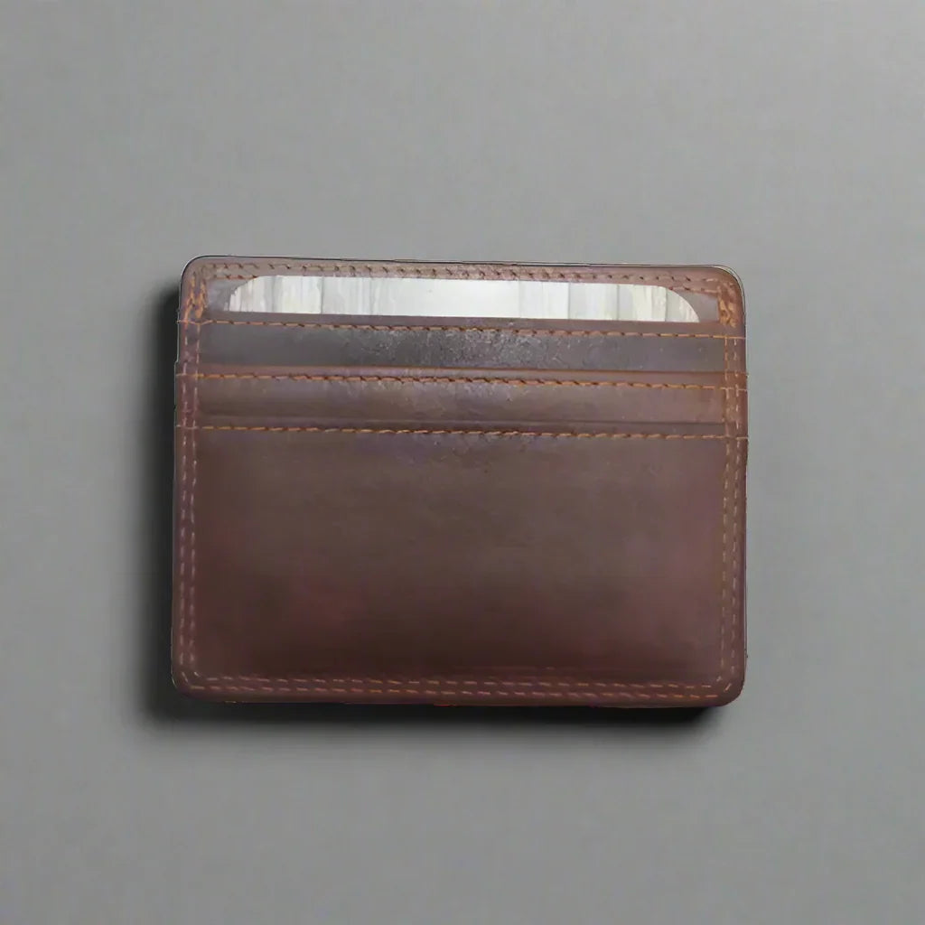 Brown leather men's credit card wallet with visible card slots on a gray background
