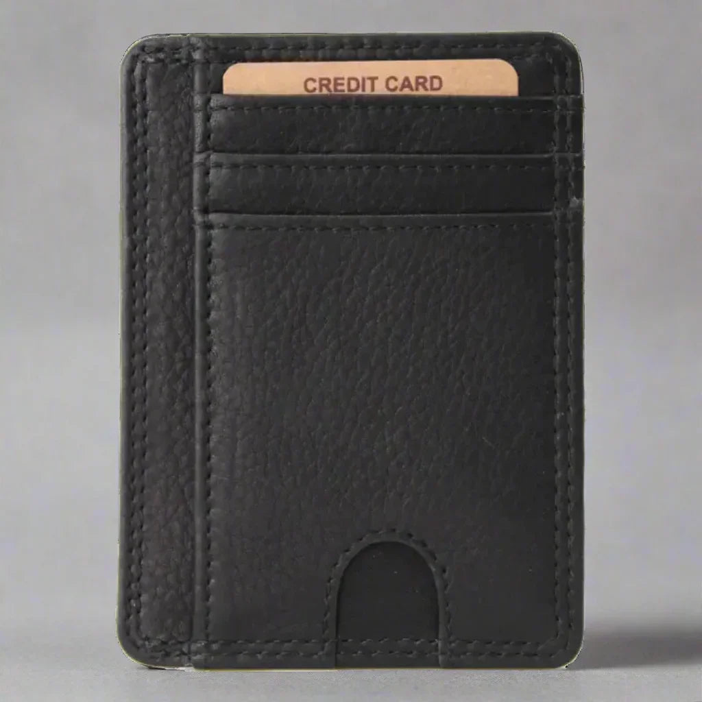 Black leather card holder wallet with visible credit card against gray background