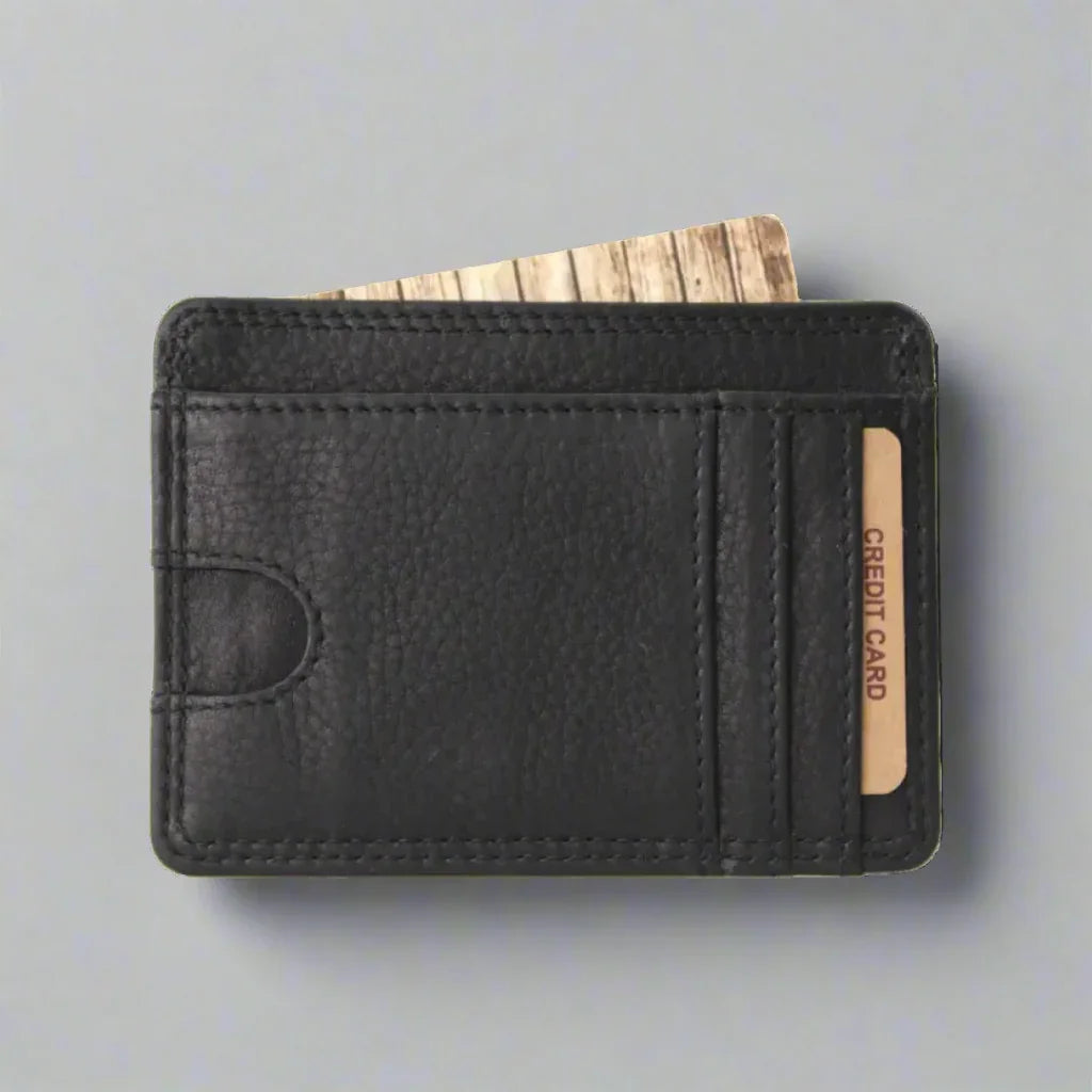 Black leather minimalist wallet with credit cards on gray background