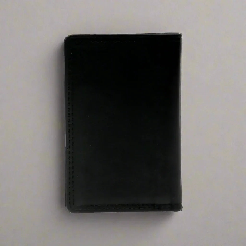 Black leather men's small credit card wallet on a plain light background