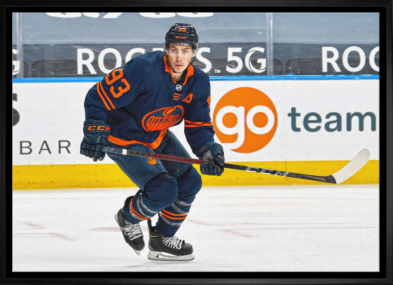 Edmonton Oilers hockey player in navy jersey skating on ice during a game