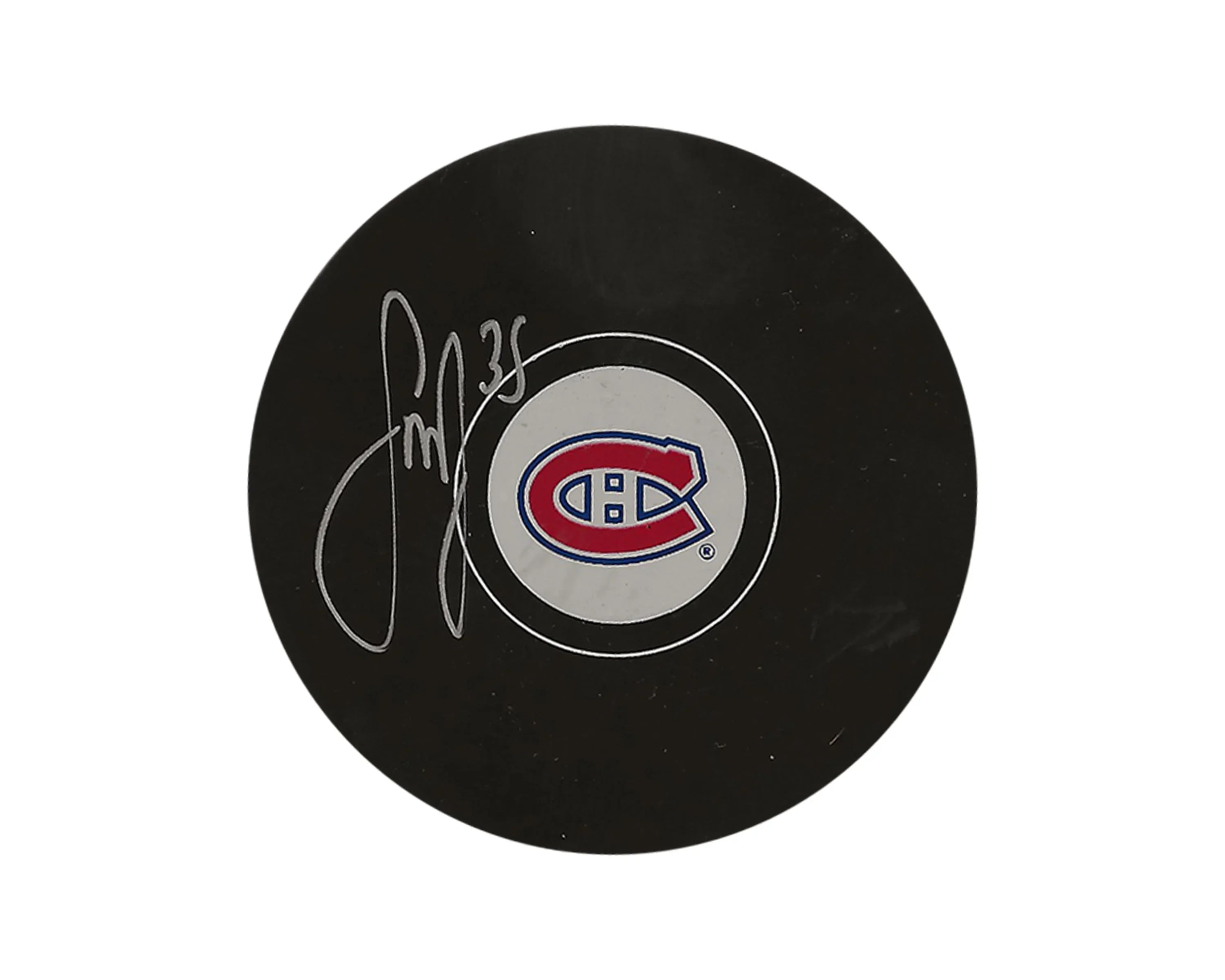 Signed Montreal Canadiens hockey puck with team logo on white background