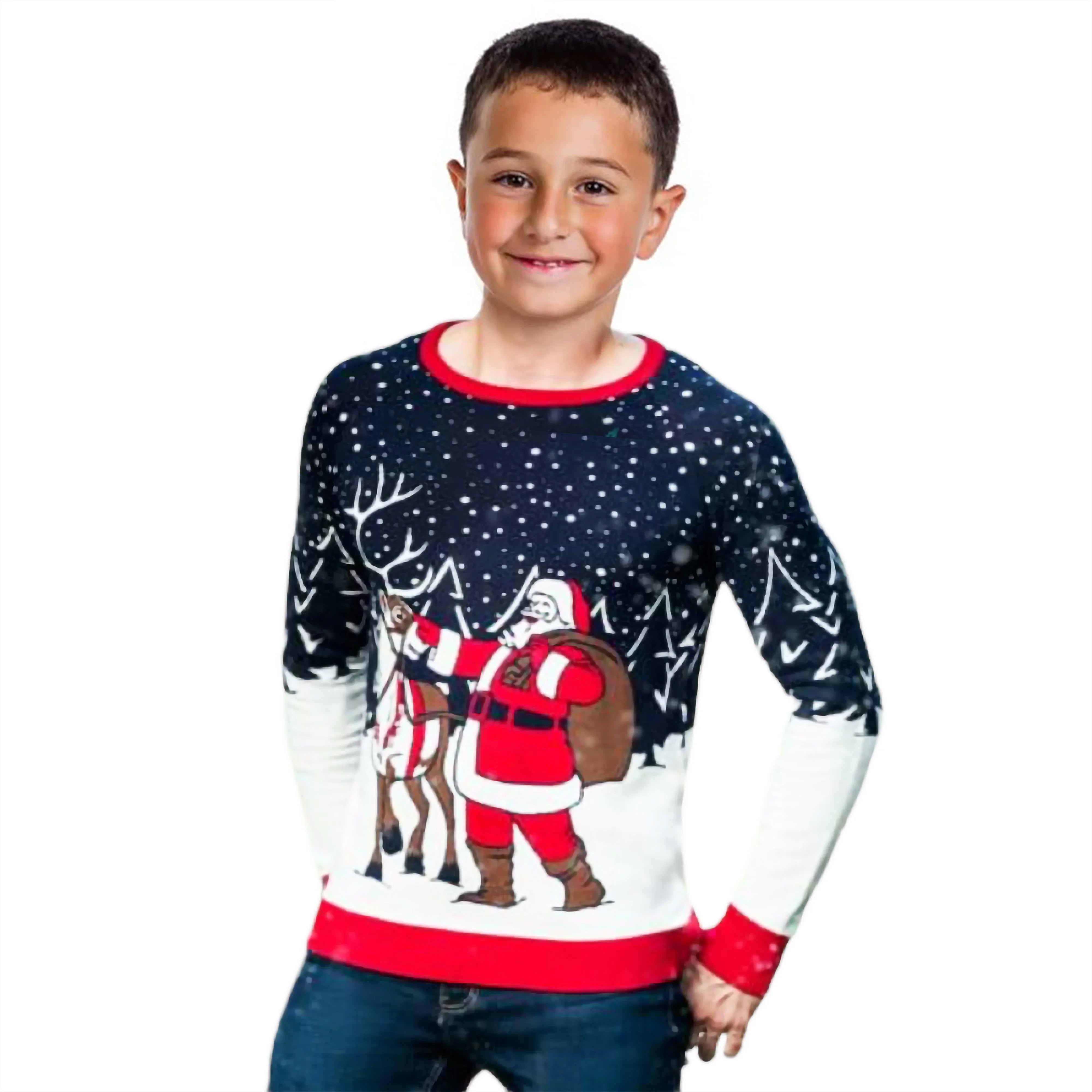 Smiling boy in festive Christmas sweater with Santa and reindeer in snowy forest scene