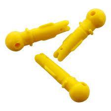 Three yellow plastic wall plugs on white background