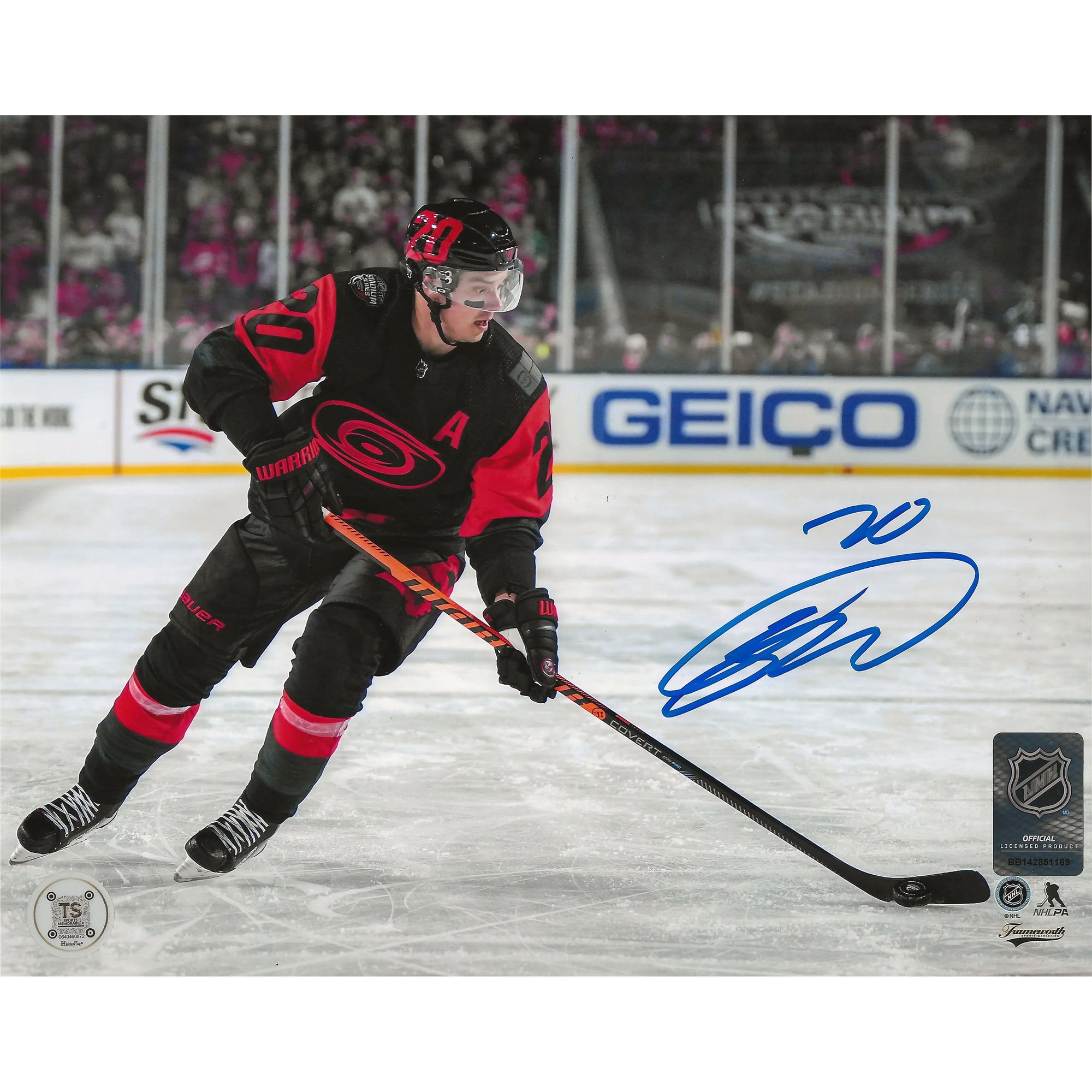 Carolina Hurricanes hockey player in black and red jersey skating on ice, signed photo