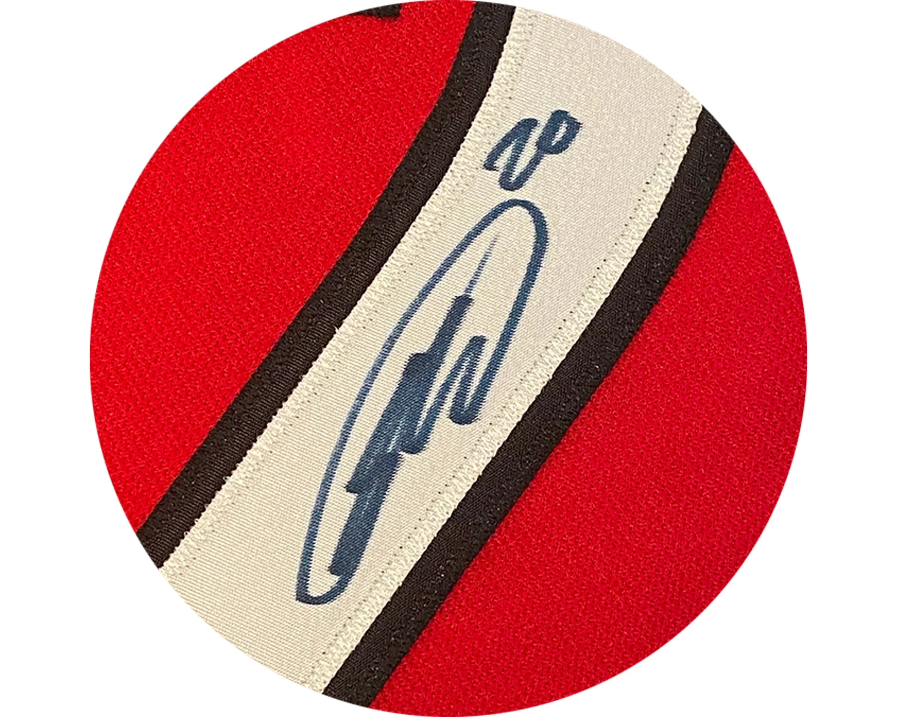 Close-up of an autograph on a red and white sports jersey fabric