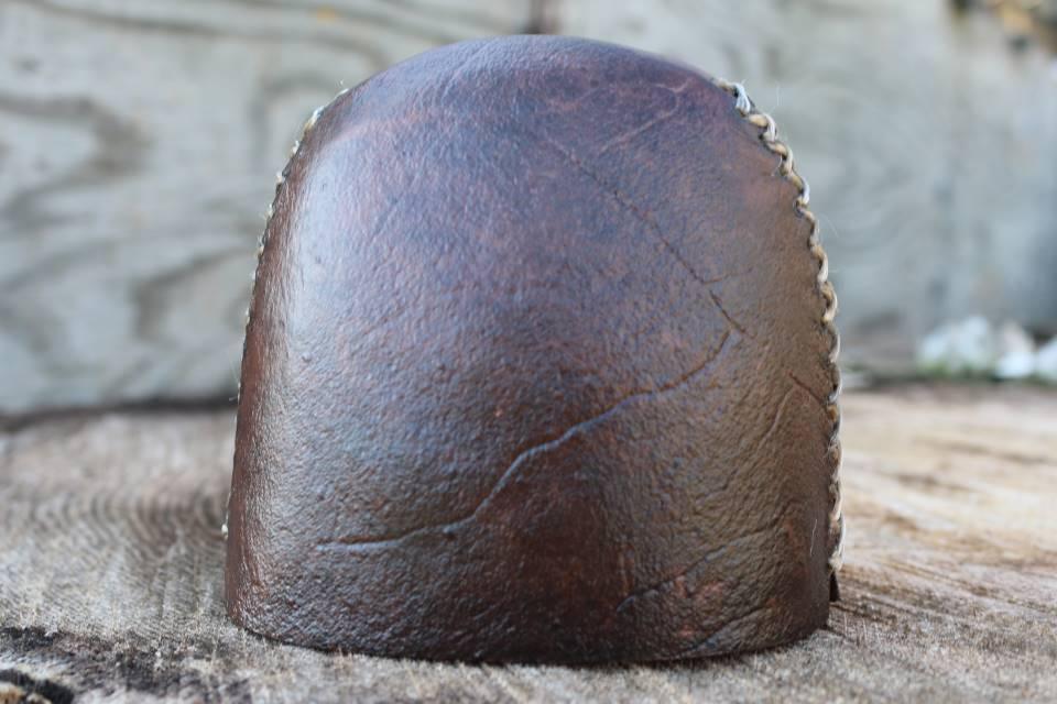 Selway Archery rawhide slide-on bow quiver cap on wood background