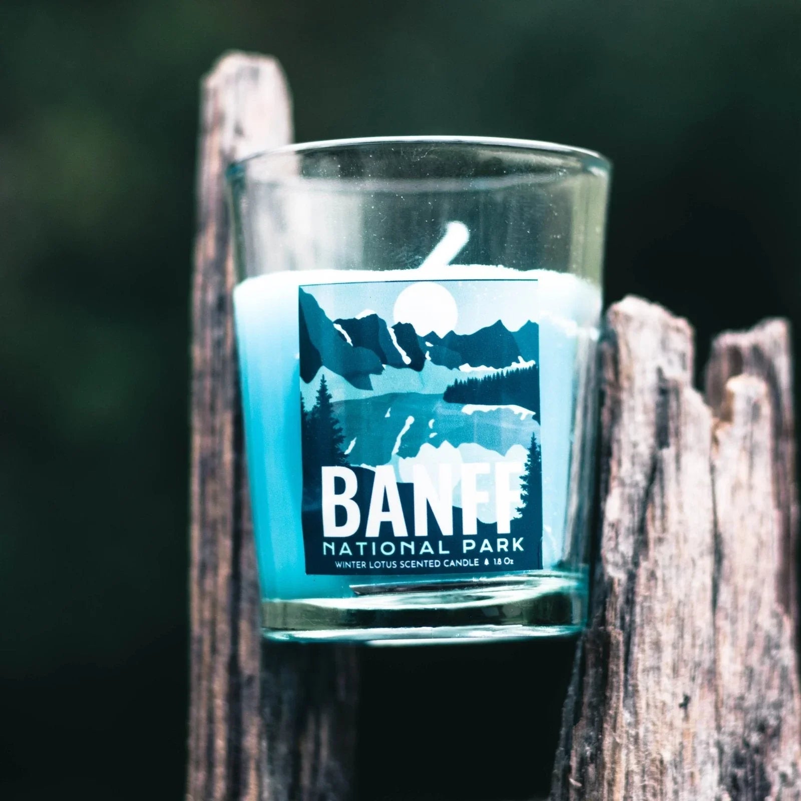 Banff National Park scented candle in glass with mountain design on rustic wood