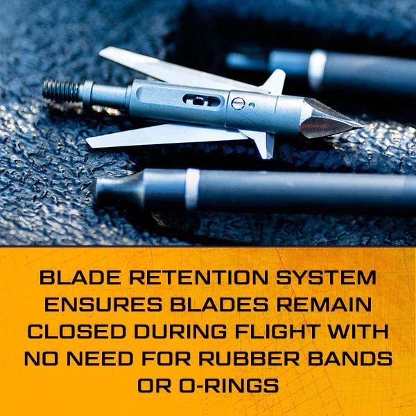 Slick Trick Archery Torch broadhead with blade retention system on textured surface