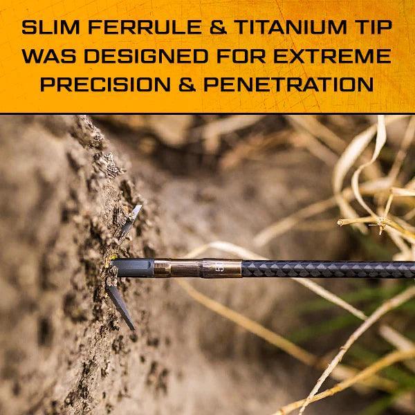 Slick Trick archery broadhead arrow embedded in dirt, close-up outdoors