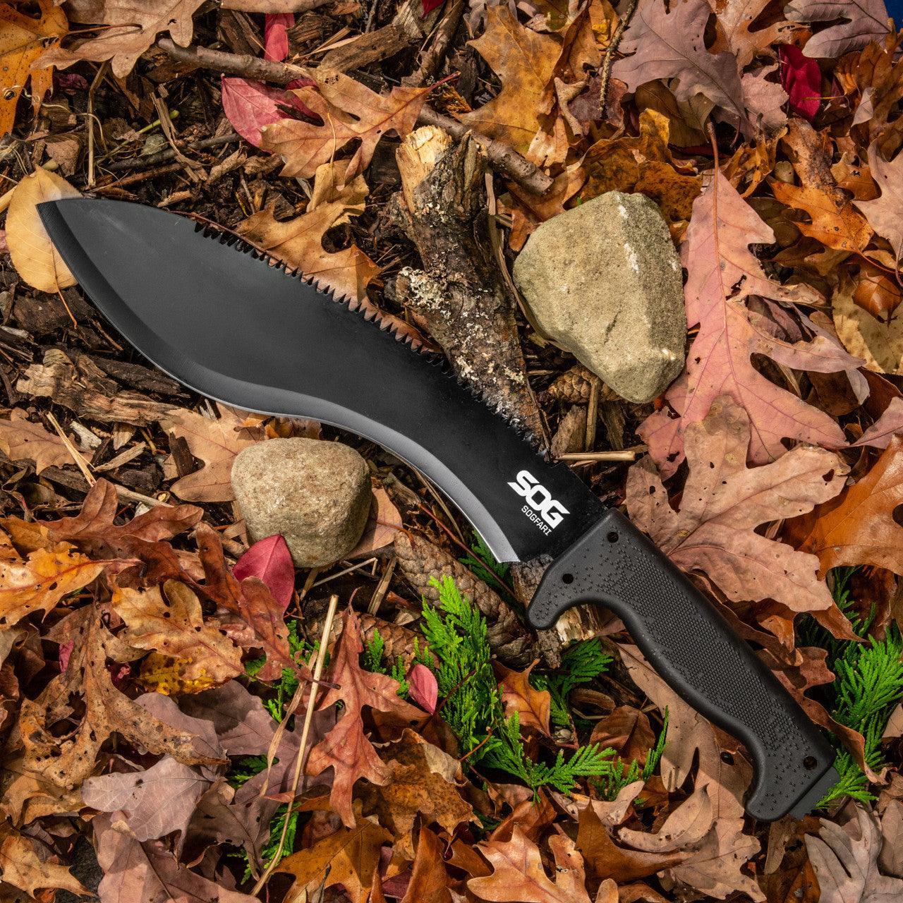 SOG SOGfari kukri machete with black handle on forest floor with autumn leaves and rocks