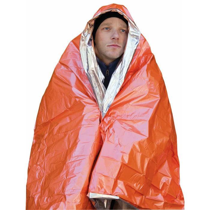 Man wearing orange emergency survival blanket, outdoor safety gear for cold weather