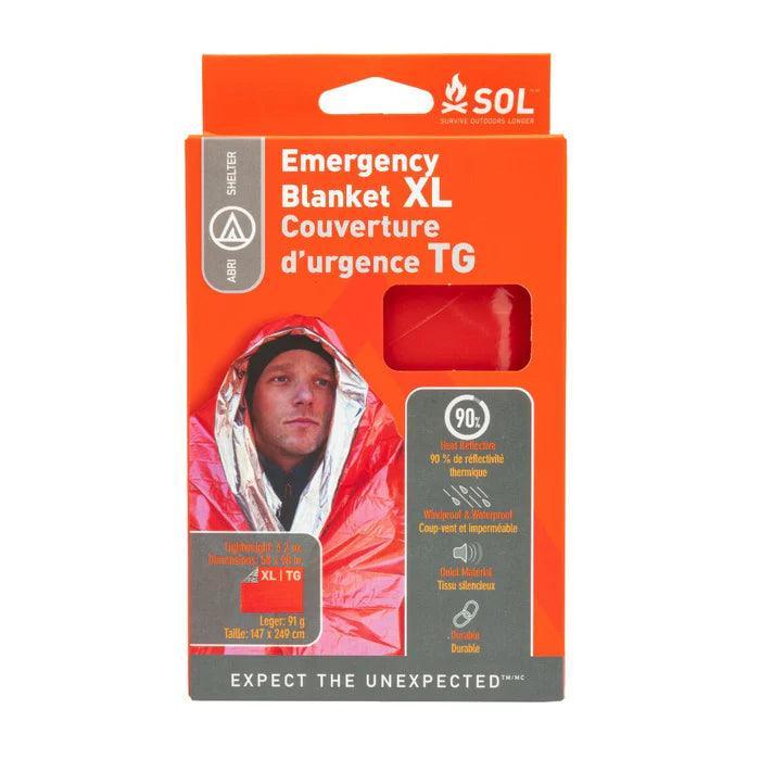 SOL Emergency Blanket XL in orange packaging, showing a person wrapped in a reflective survival blanket.