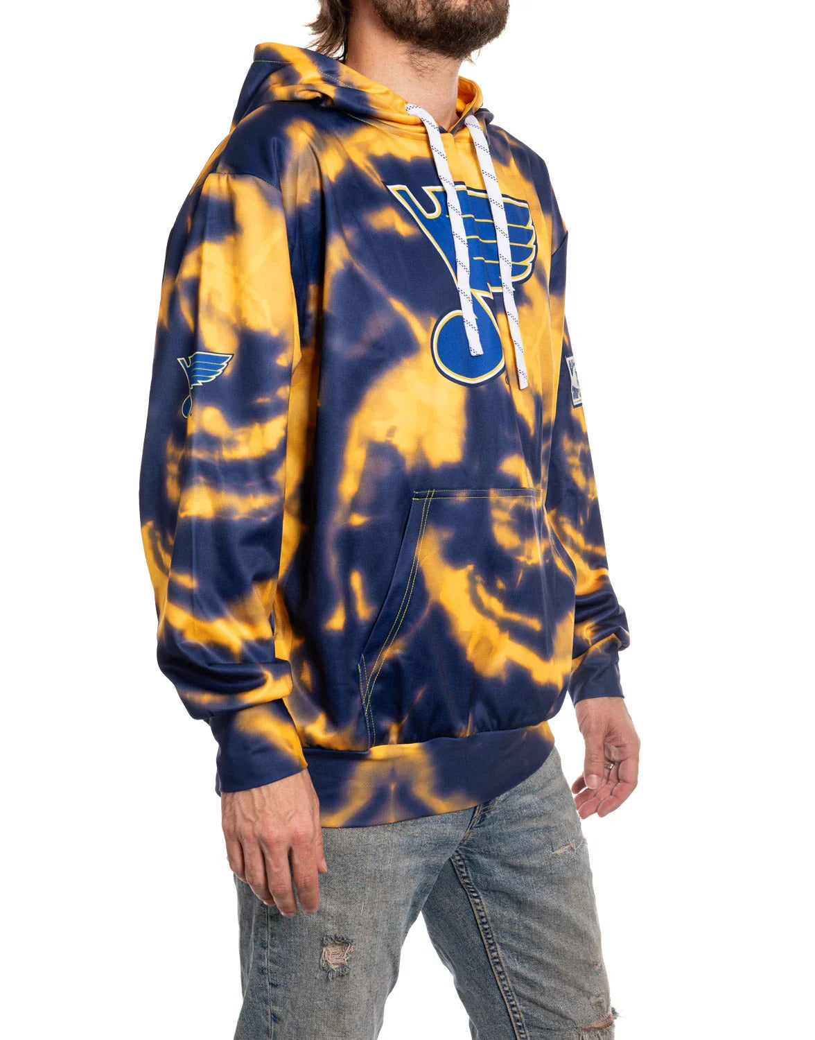 Man wearing St. Louis Blues blue and gold tie-dye hoodie with team logo, side view