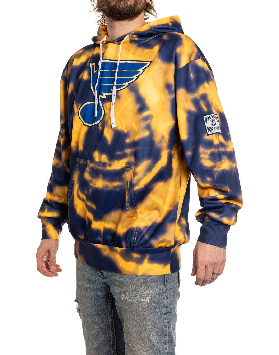 Man wearing blue and yellow tie dye St. Louis Blues hoodie with large team logo