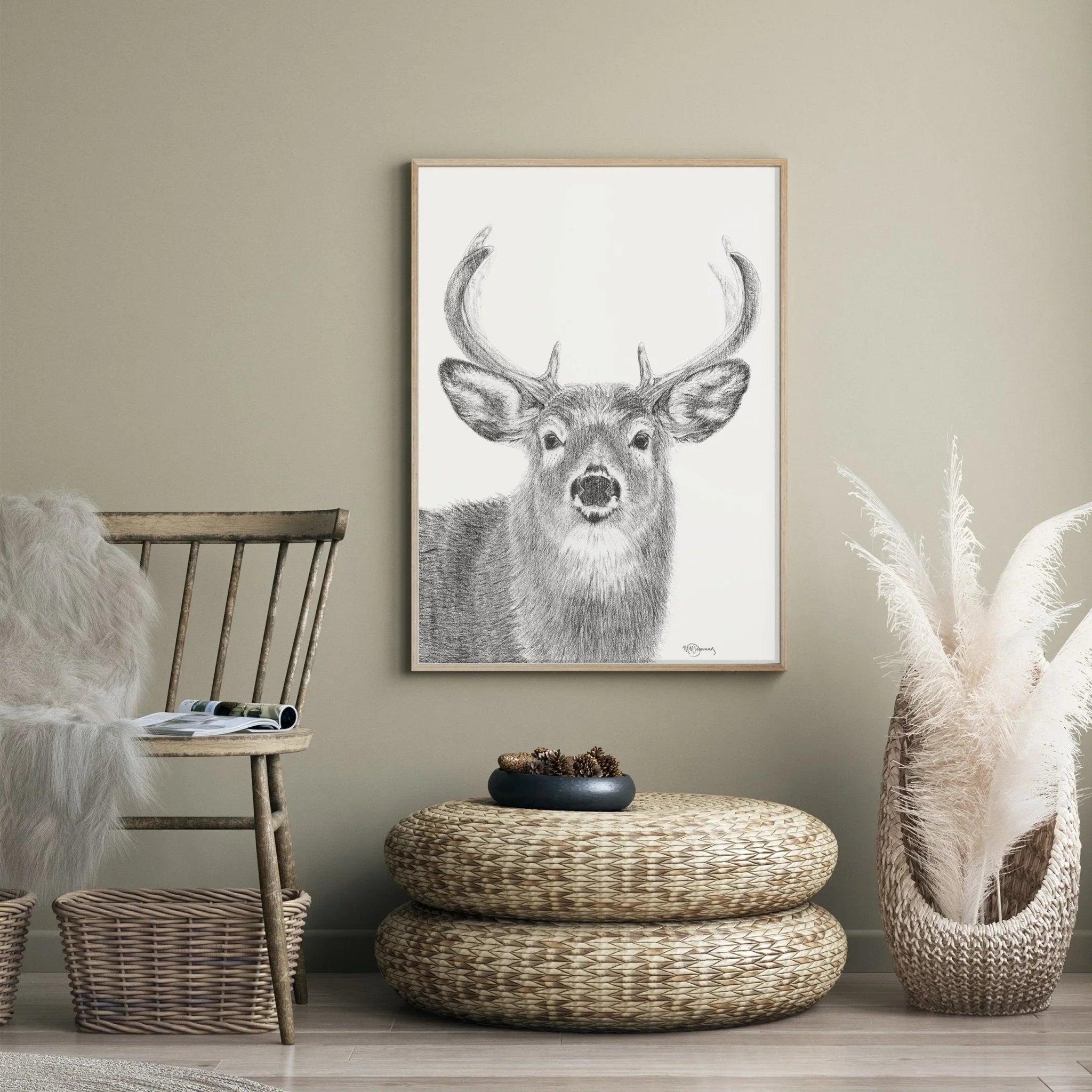 Deer sketch wall art in modern neutral living room with wicker furniture and decor