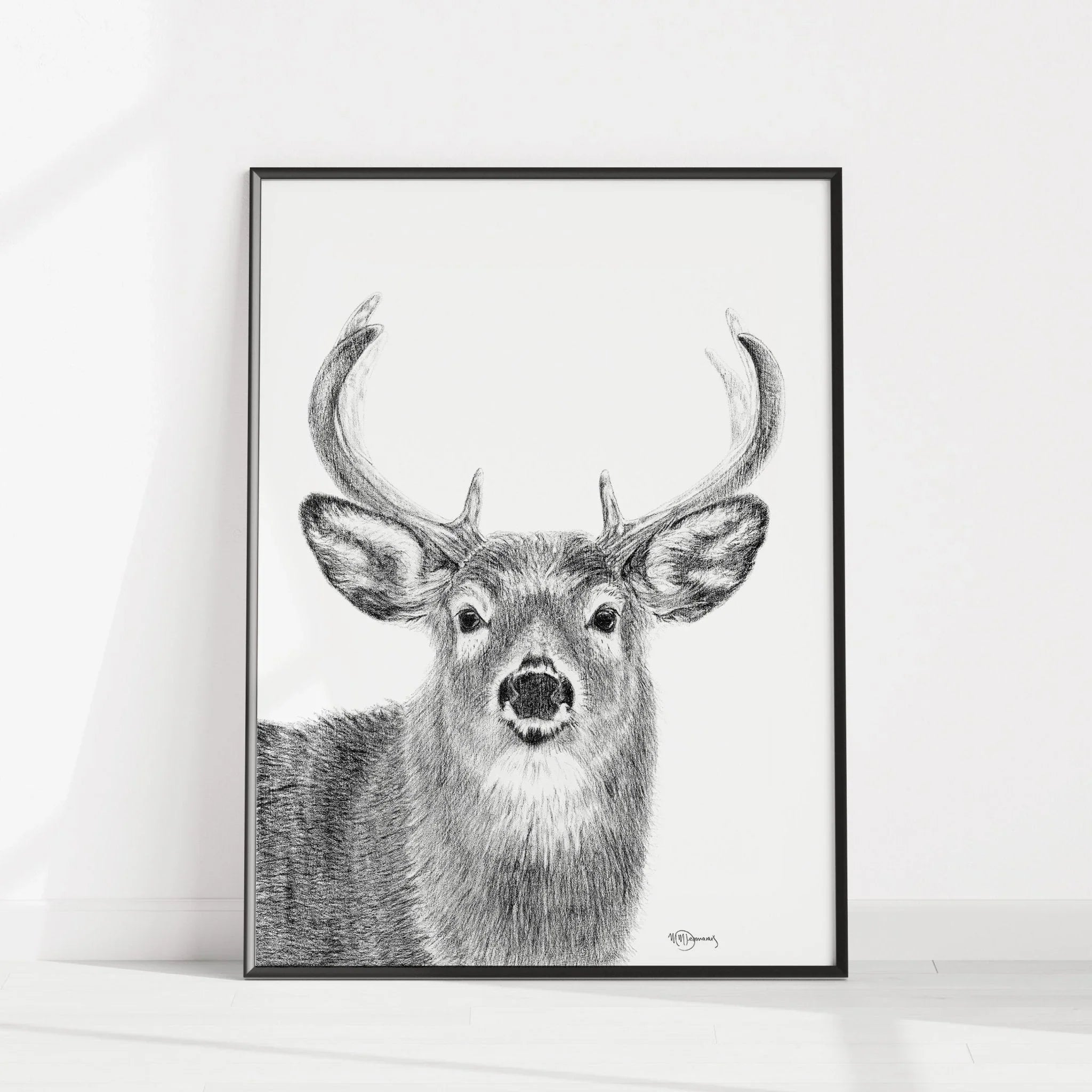 Minimalist black and white deer stag illustration in a modern frame on white wall