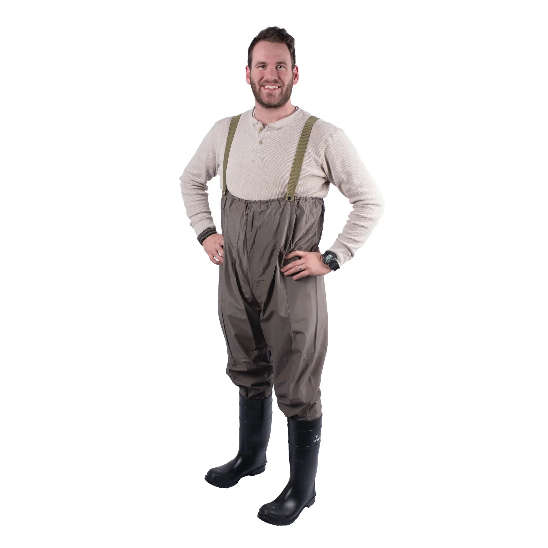 Man wearing brown fishing waders with suspenders and black rubber boots on white background